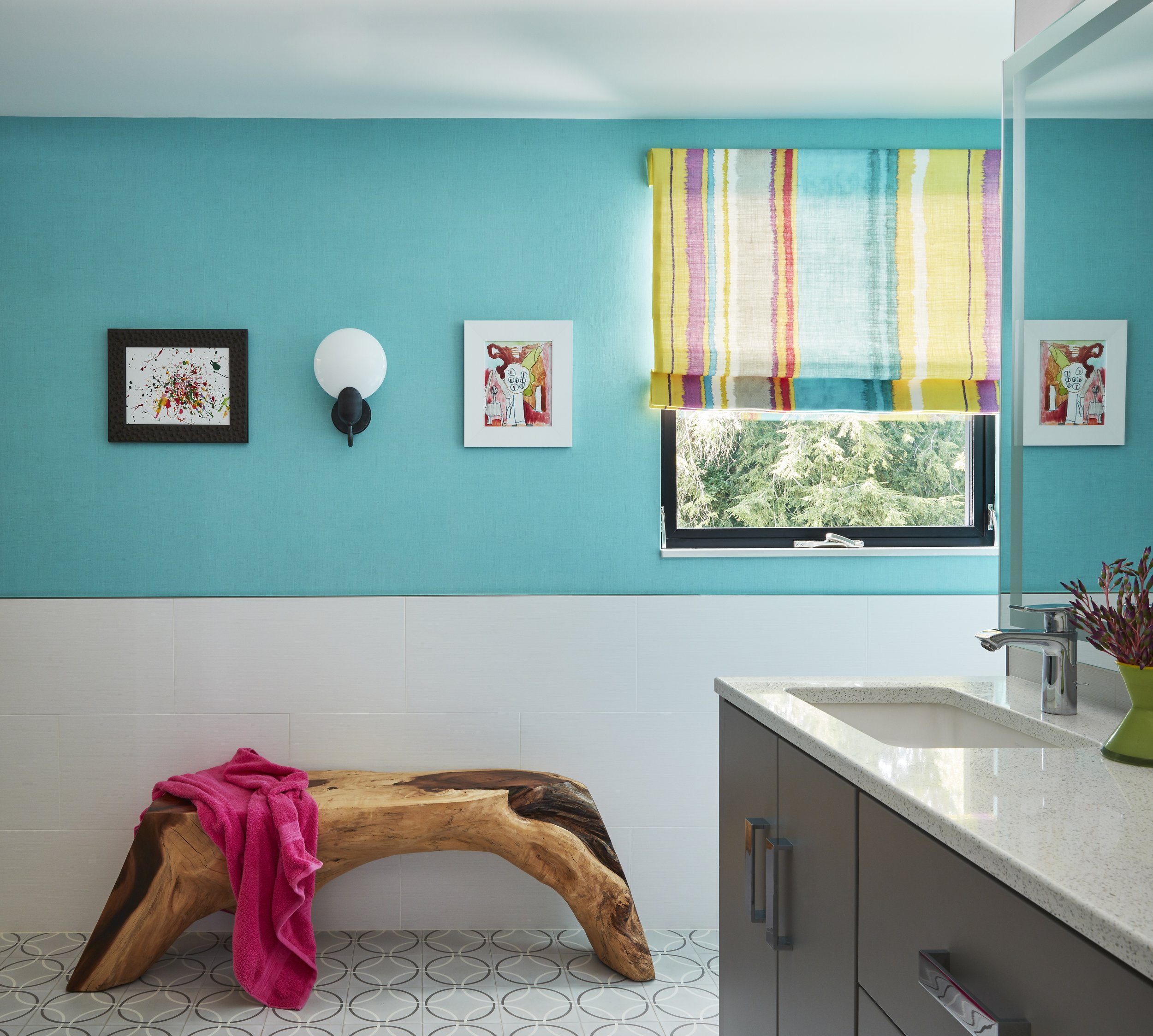 playful bathroom with double sink, white quart counters and teal paint color adds a touch of fun

