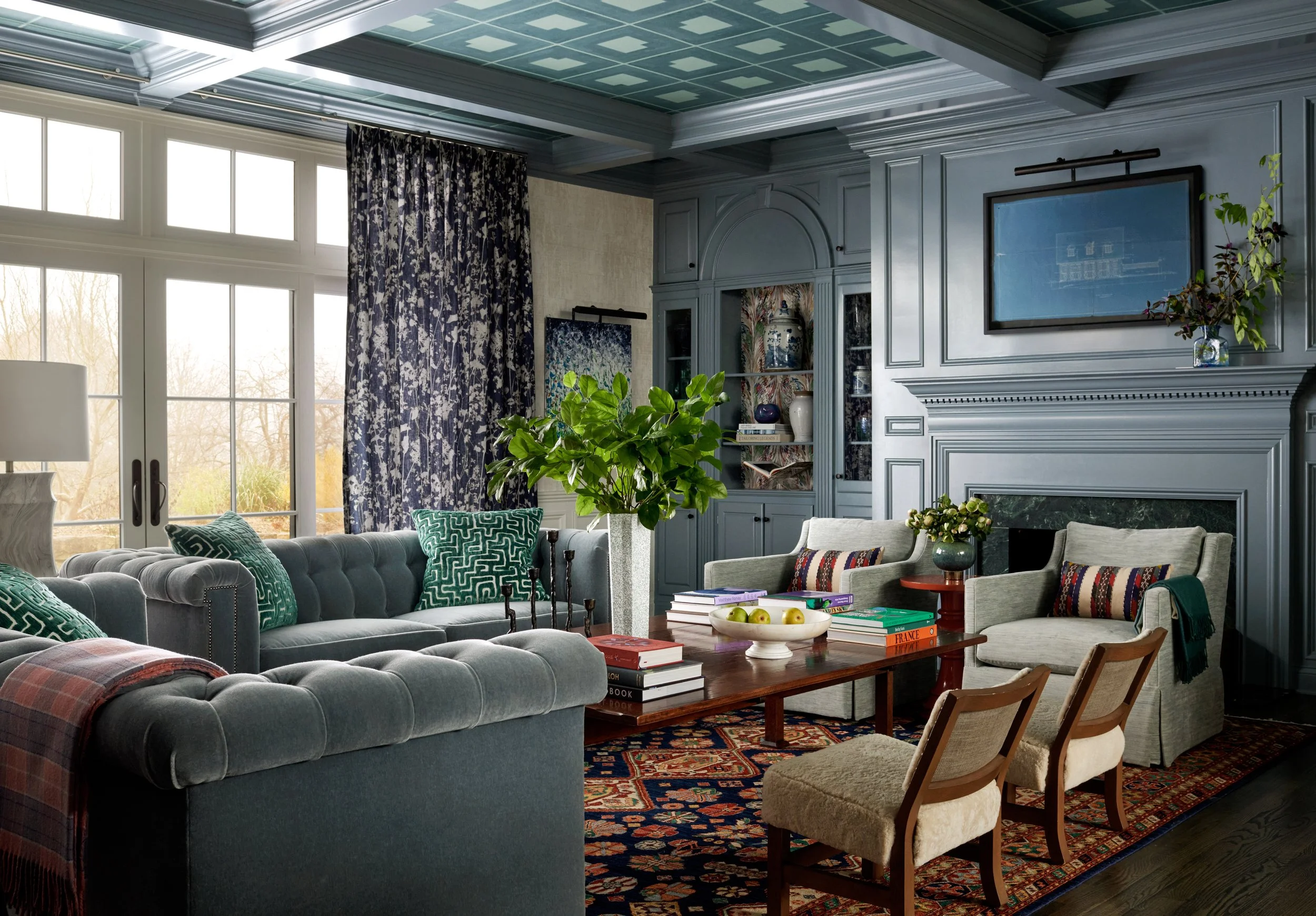 Beautiful blue toned living room with playful prints and fabrics. 