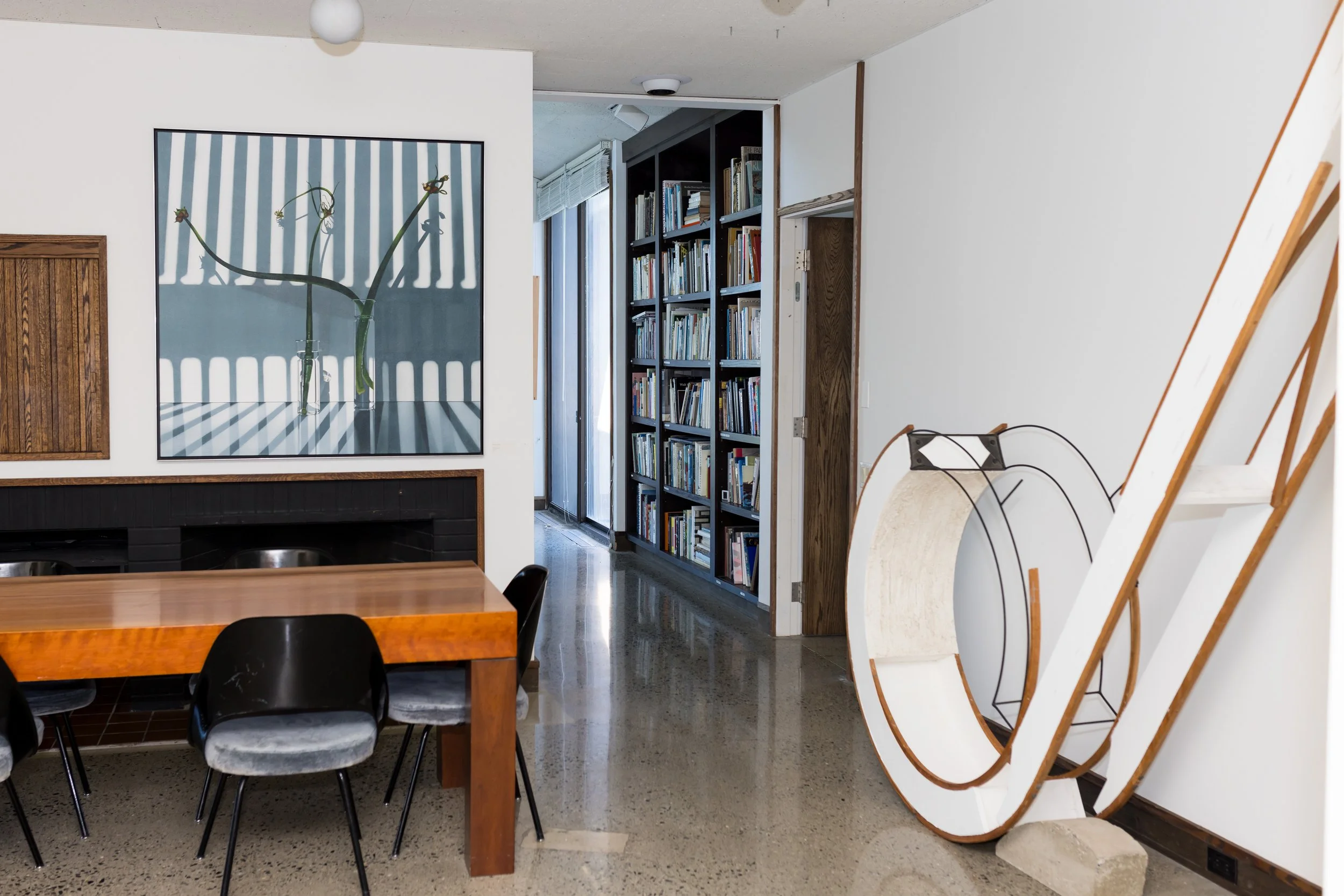 Modern interior with dining area, art, and bookshelf