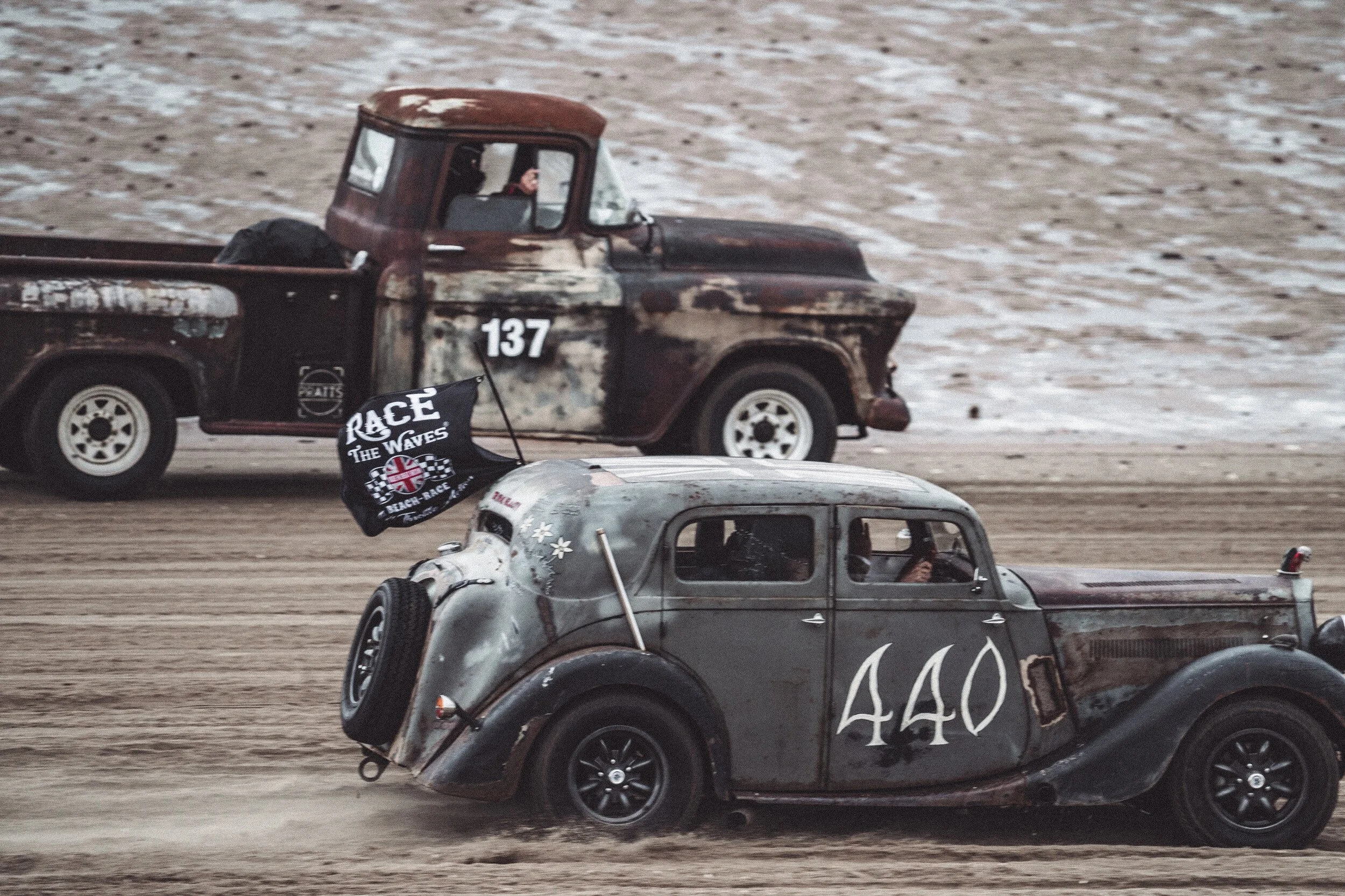 Hot rods racing on a beach