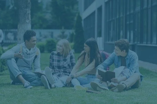 Teenagers talking outside with books