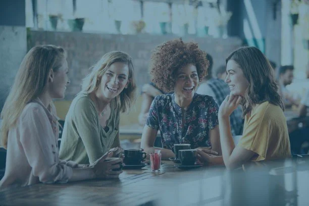 Women talking and sharing coffee together