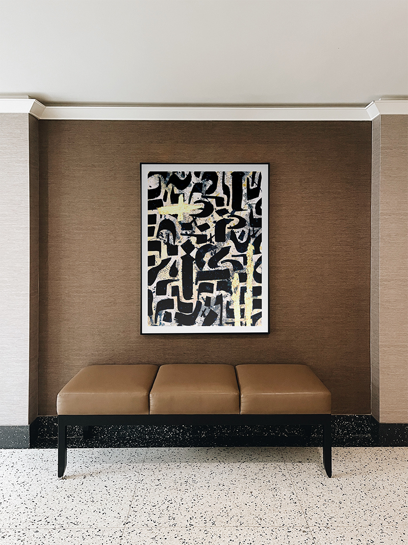 Ligraphy on Gold by Five46 framed and displayed above a leather bench in a modern interior space, contemporary abstract wall art print from Landson Studios.