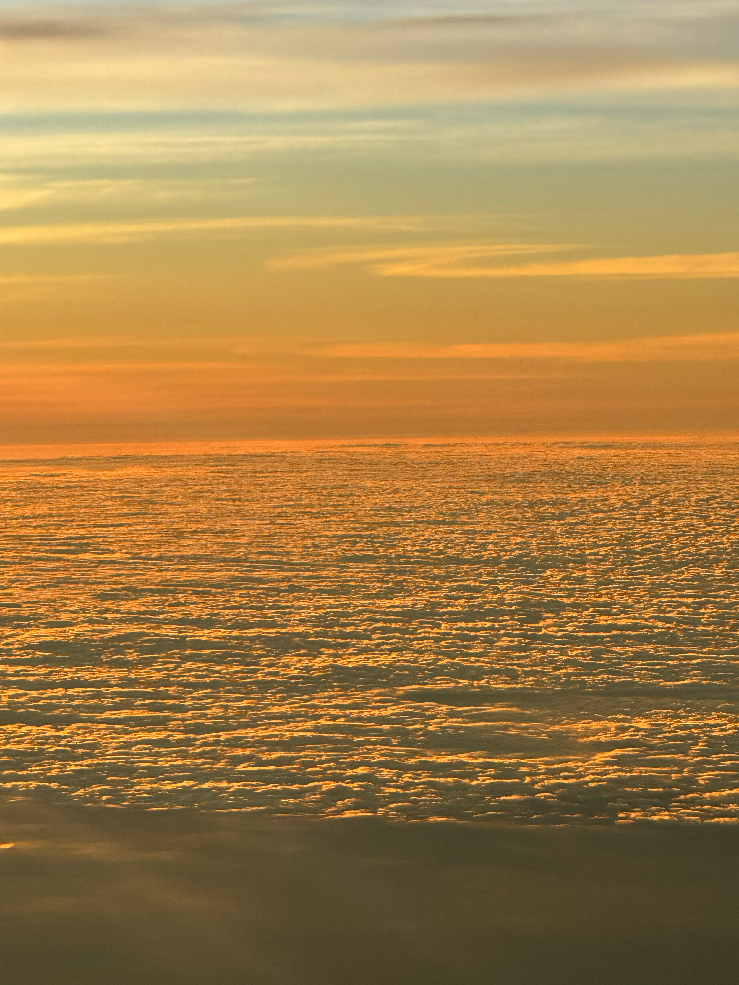 Above the Clouds by Dakota, contemporary photographic giclée print depicting sunlit cloud formations with subtle gradients of gold and blue, curated by Landson Studios.