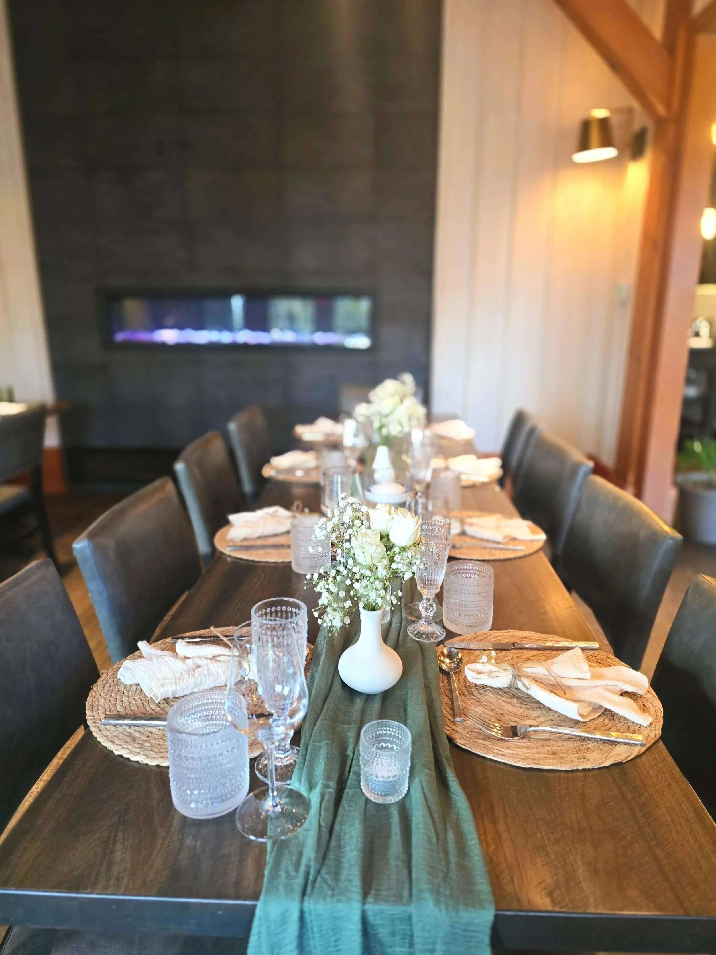 Dinner tablescape with sage green runner and flowers