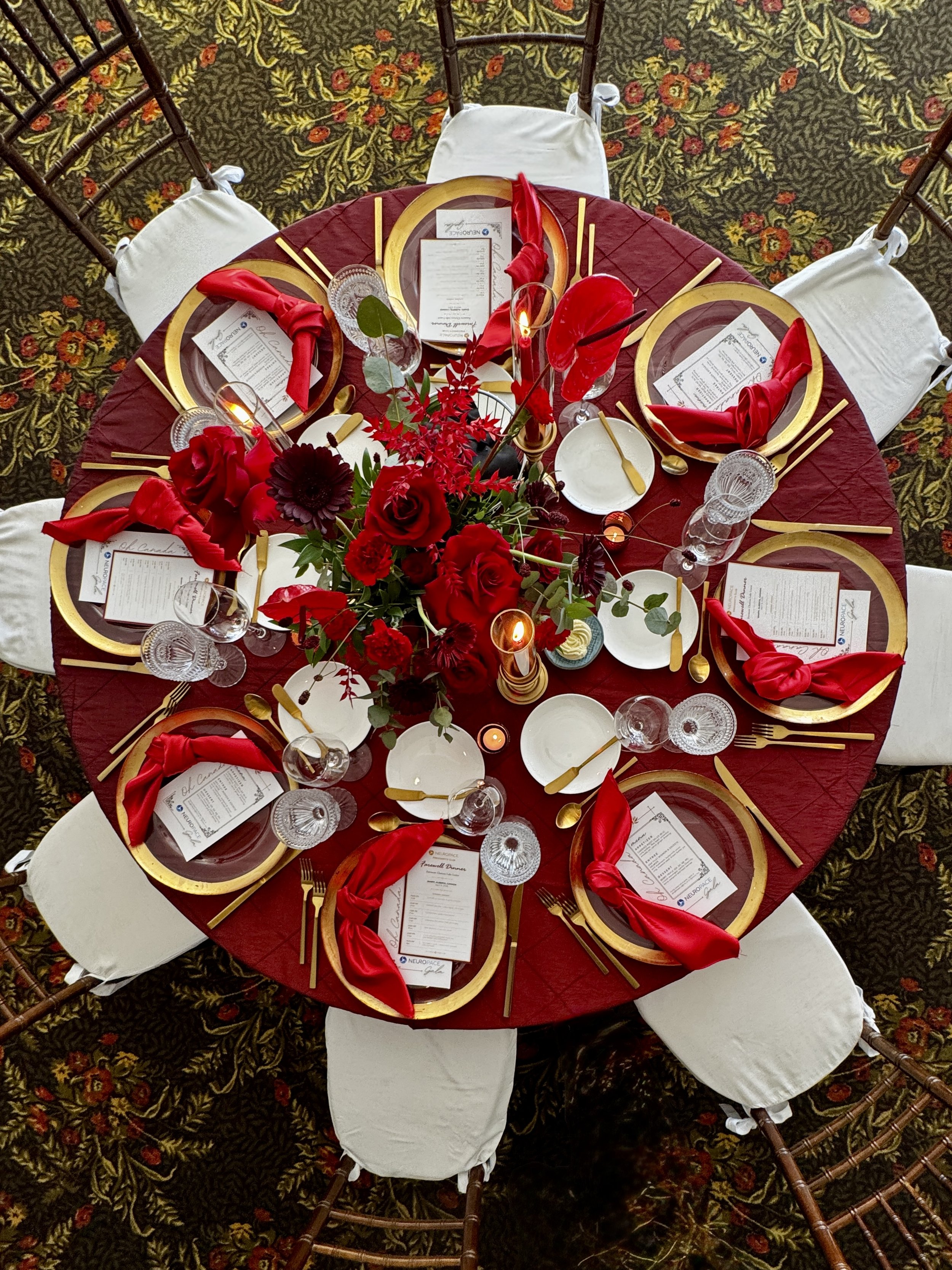 Round table at corporate event with red decorations
