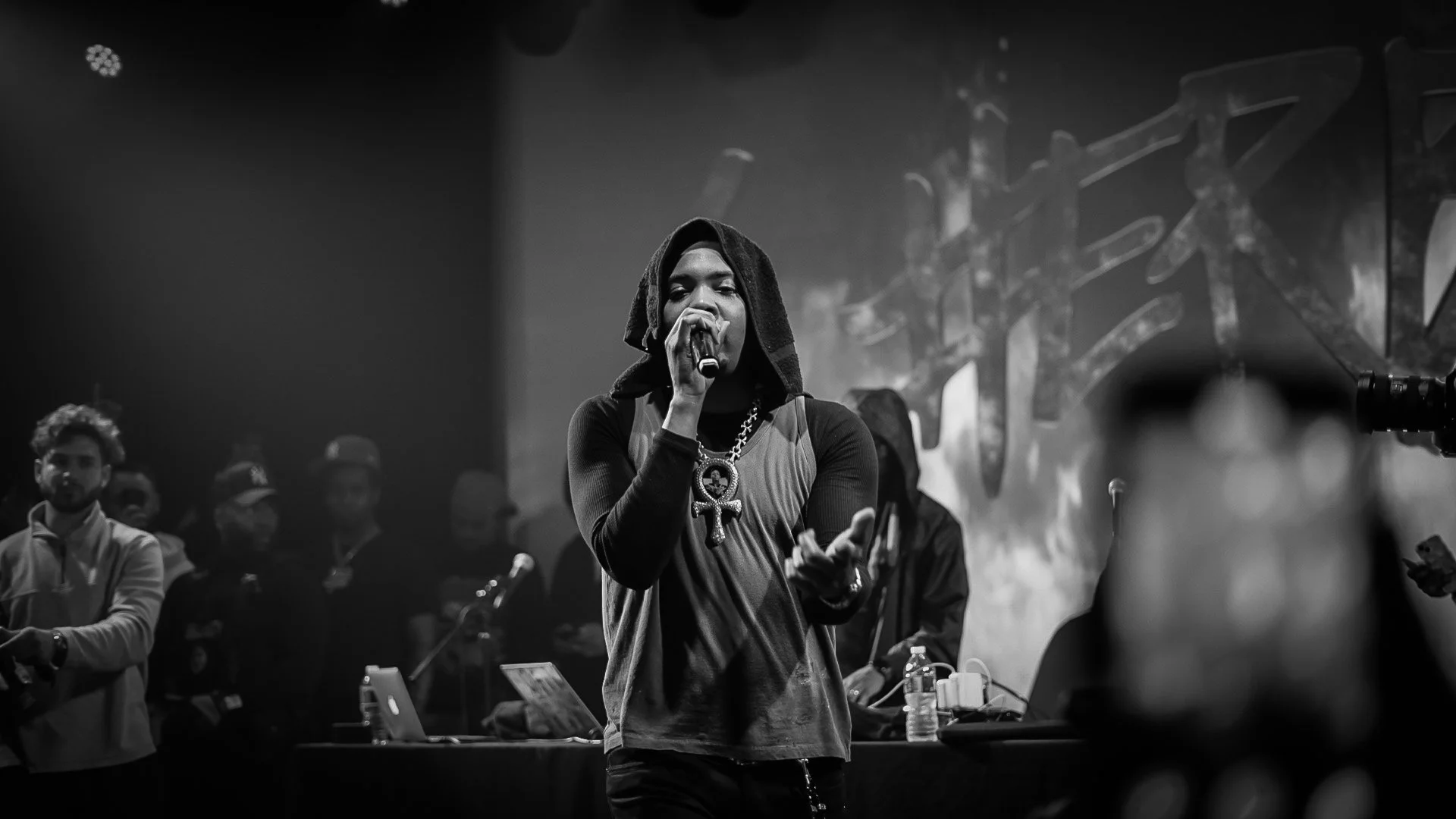 G Herbo Singing into Mic pointing to Crowd, with G Herbo stage sign behind him