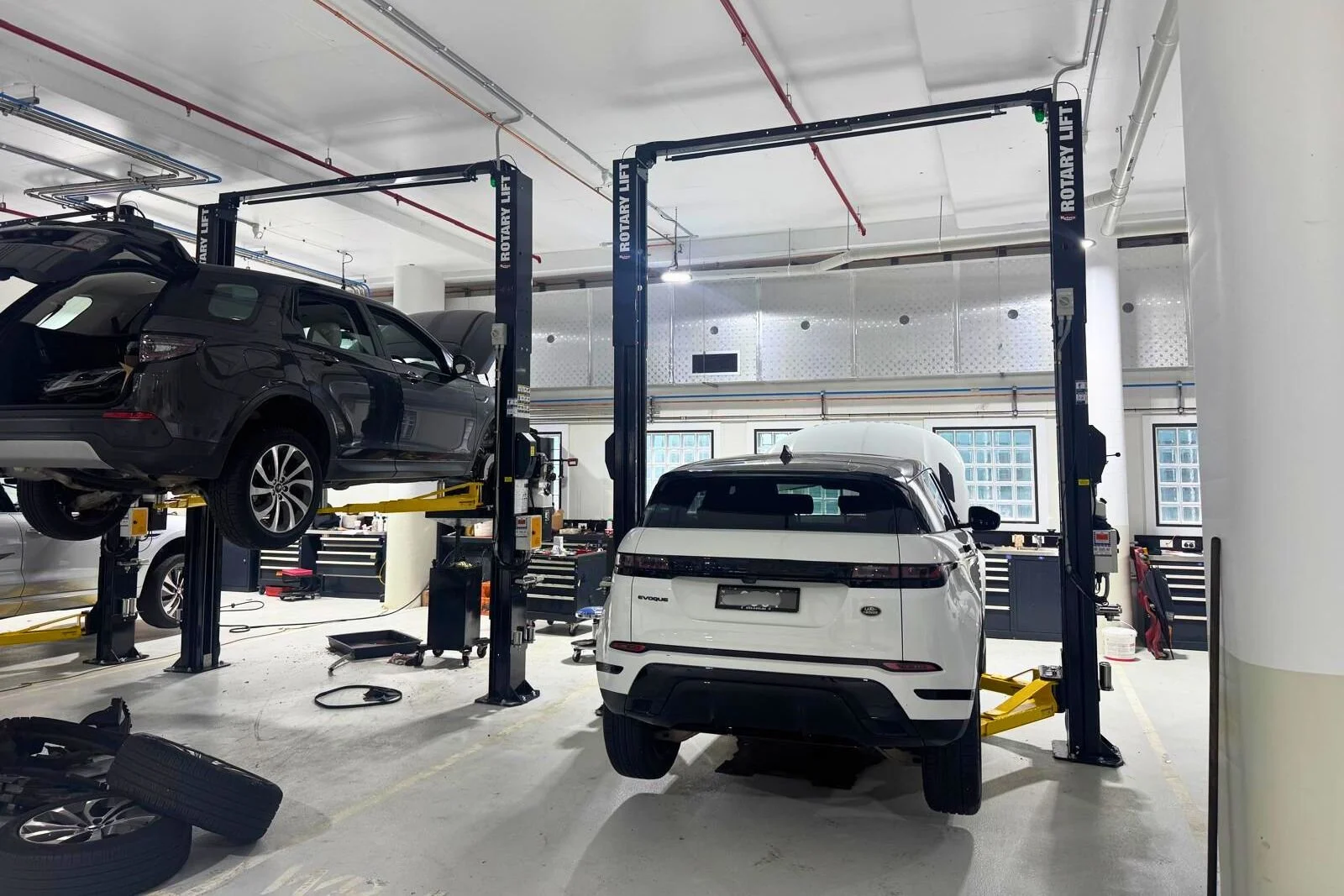 Automotive workshop in Artarmon NSW featuring multiple Rotary two post vehicle hoists installed for dealership servicing.