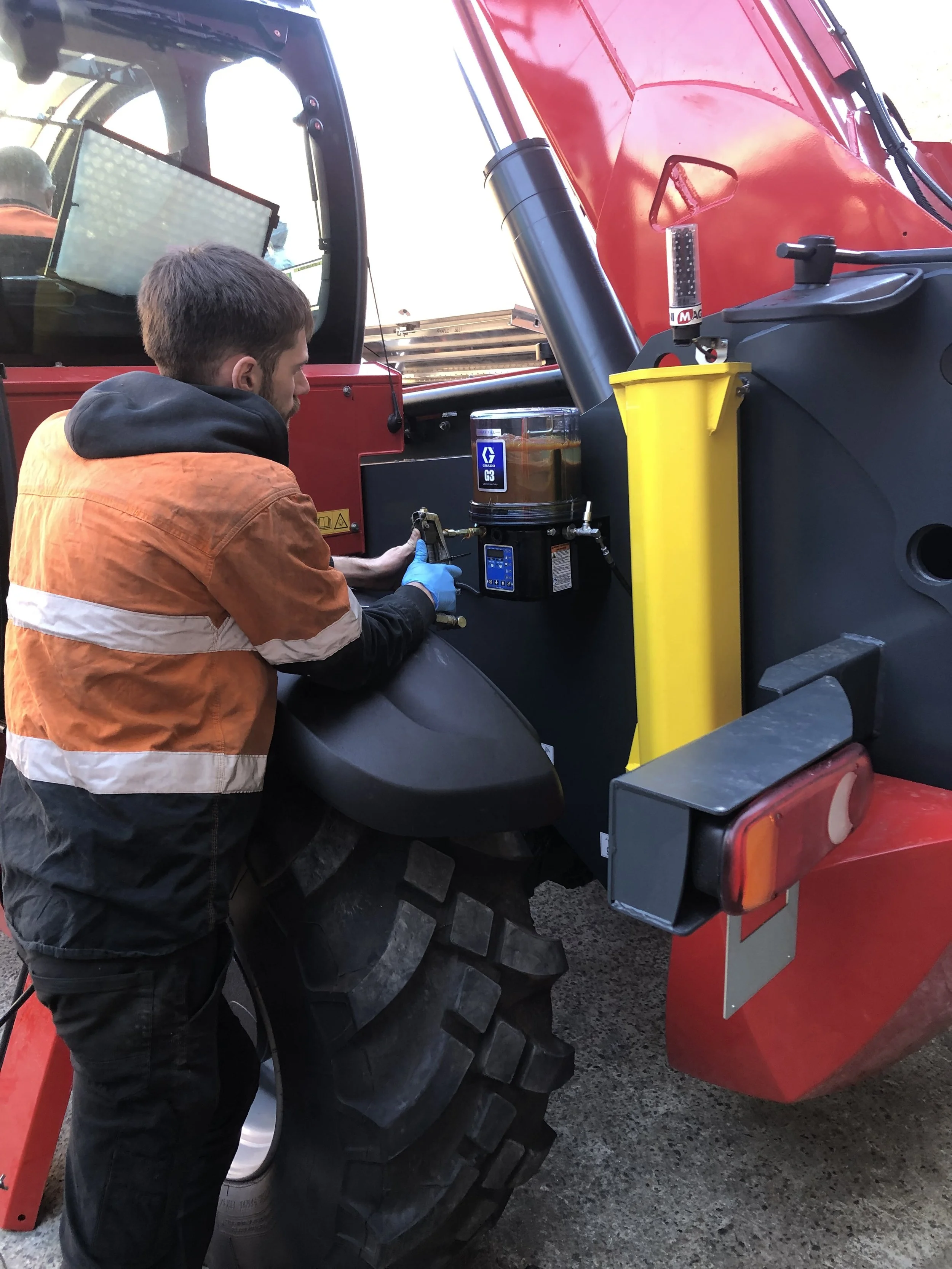 TWSA technician installing Graco G3 automatic grease lubrication system on heavy equipment in NSW for reliable maintenance automation