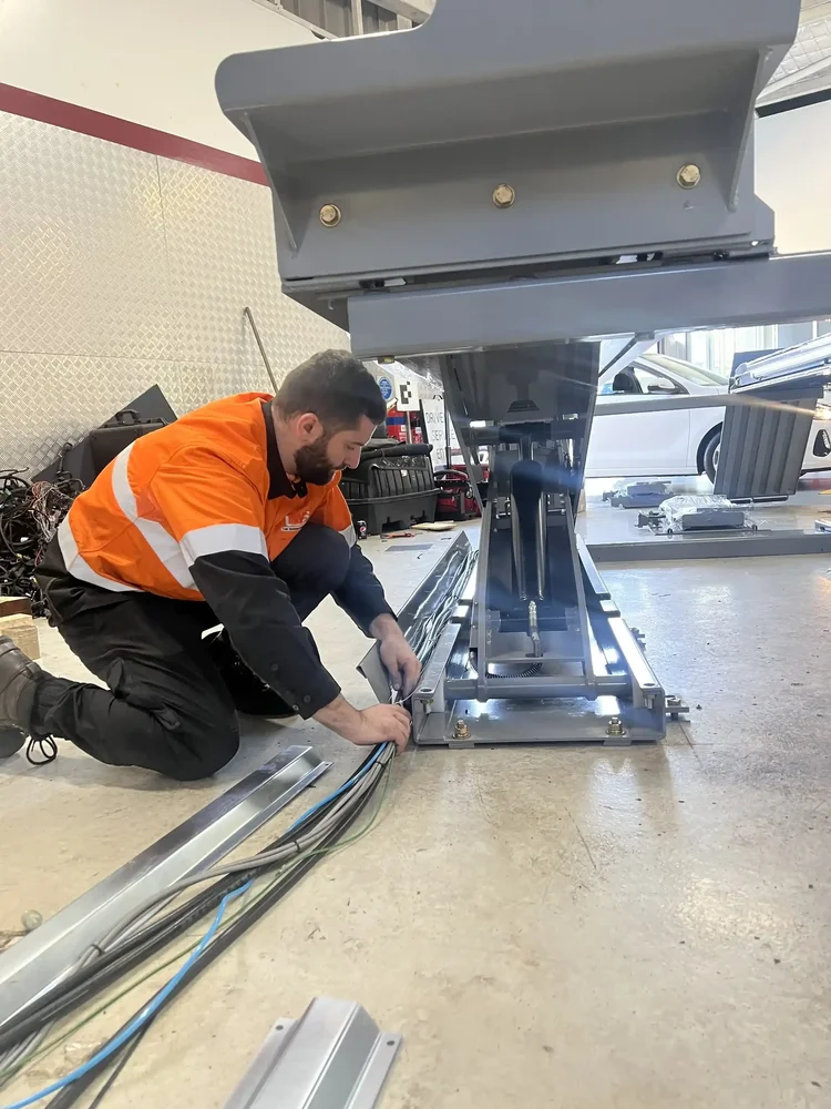 TWSA technician servicing workshop equipment