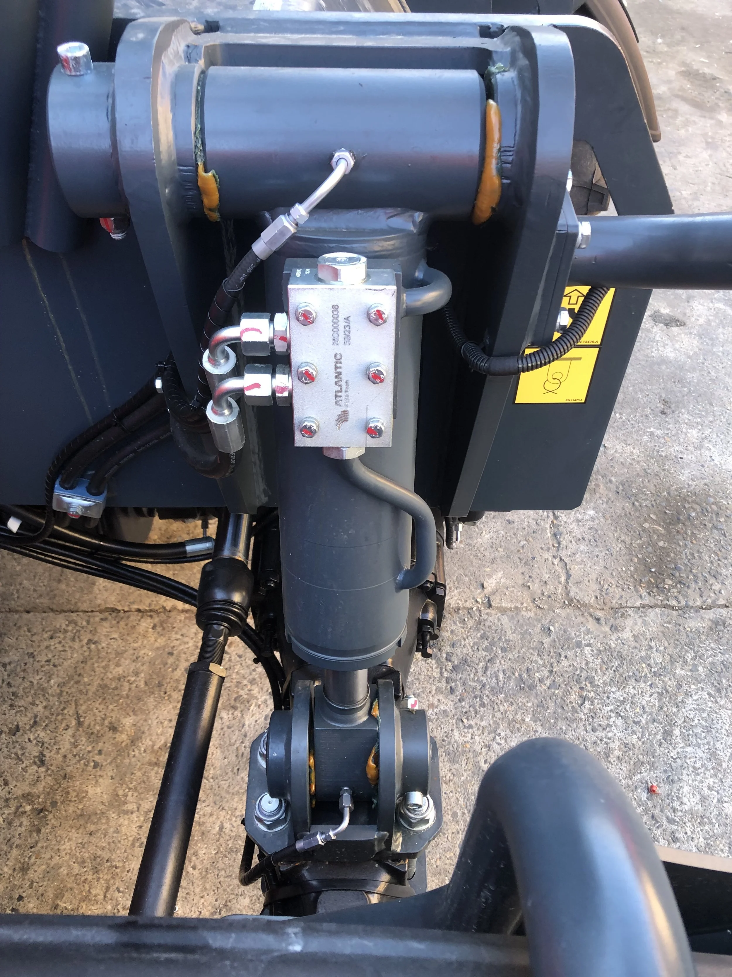 Close-up of TWSA-installed automatic grease lubrication system on heavy machinery hydraulic joint in NSW for smoother equipment operation