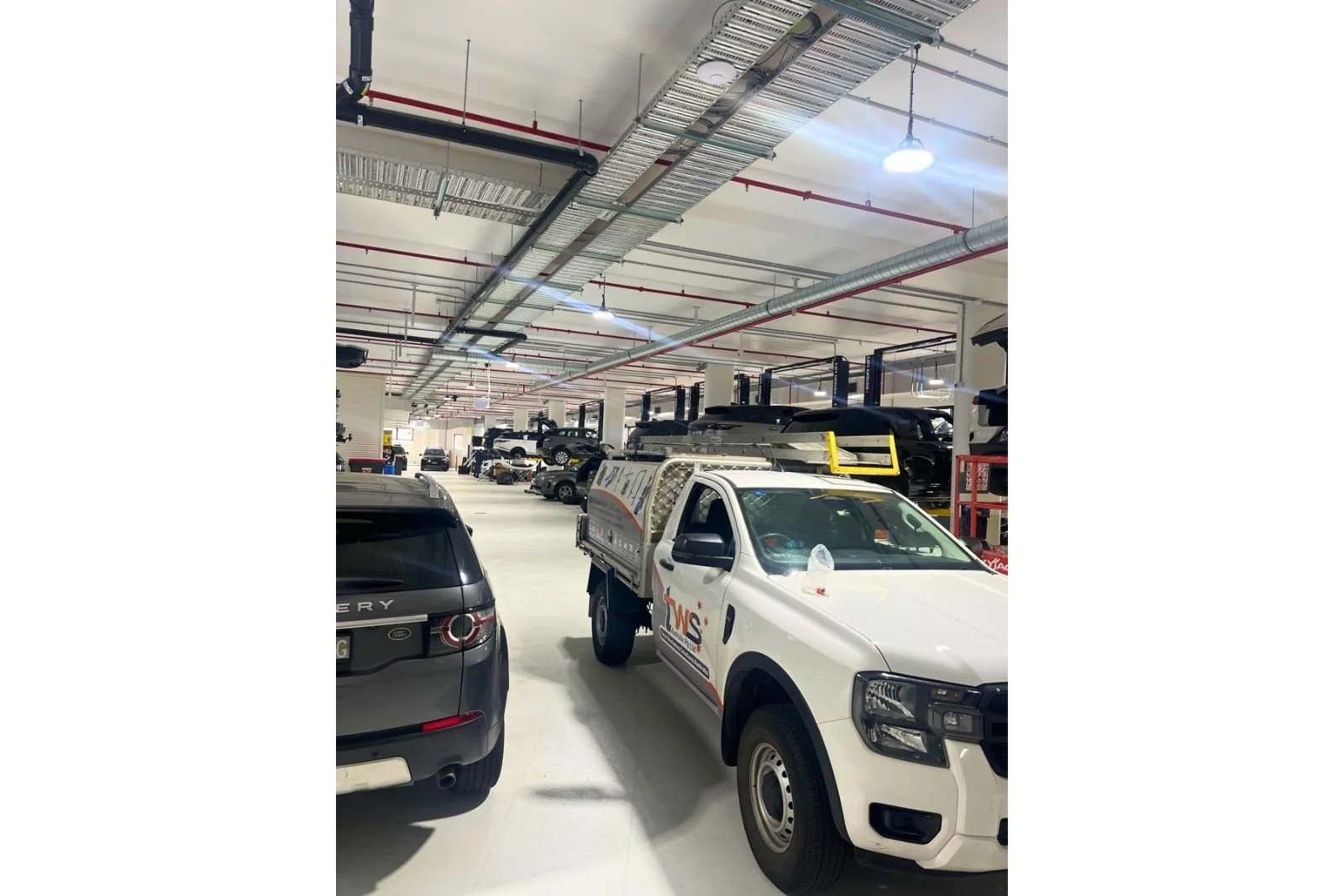 Automotive workshop ventilation ducting system installed to improve air quality and exhaust extraction in Artarmon NSW.
