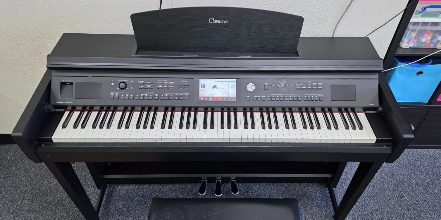 A Yamaha Clavinova piano with a control panel and touchscreen.