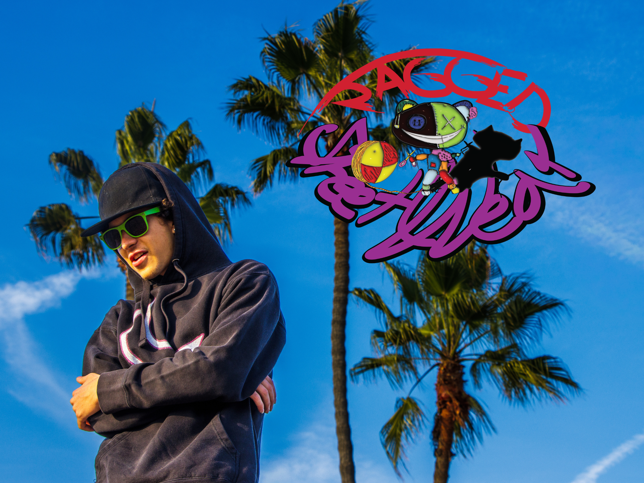 A young man wearing a backwards baseball cap and green sunglasses, standing outdoors with his arms crossed. Behind him are tall palm trees and a bright blue sky.