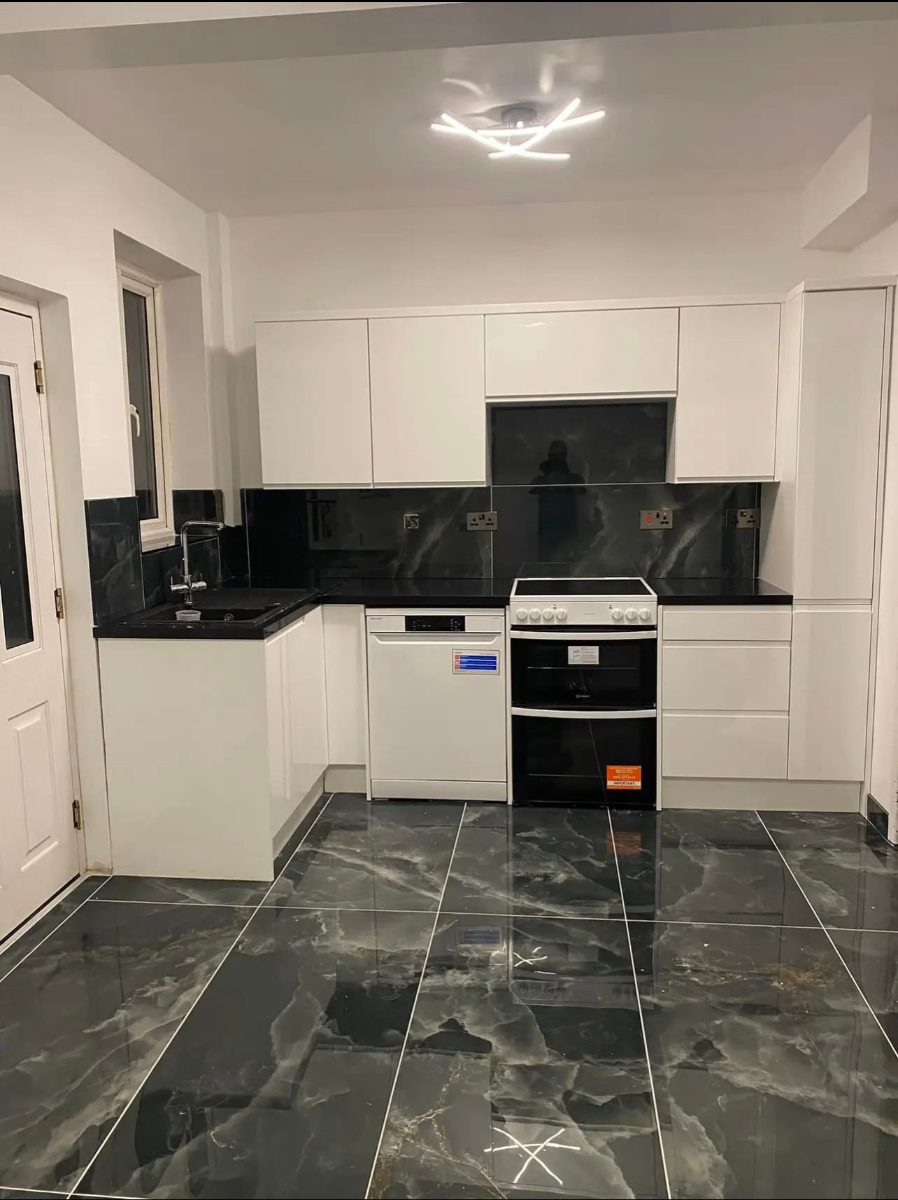 modern kitchen with laminated floor and white cabinets