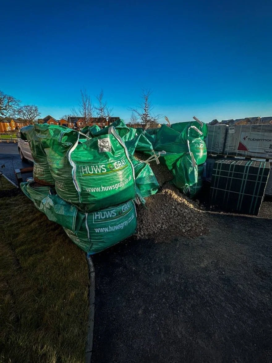 Green Mot bags next to other paving materials