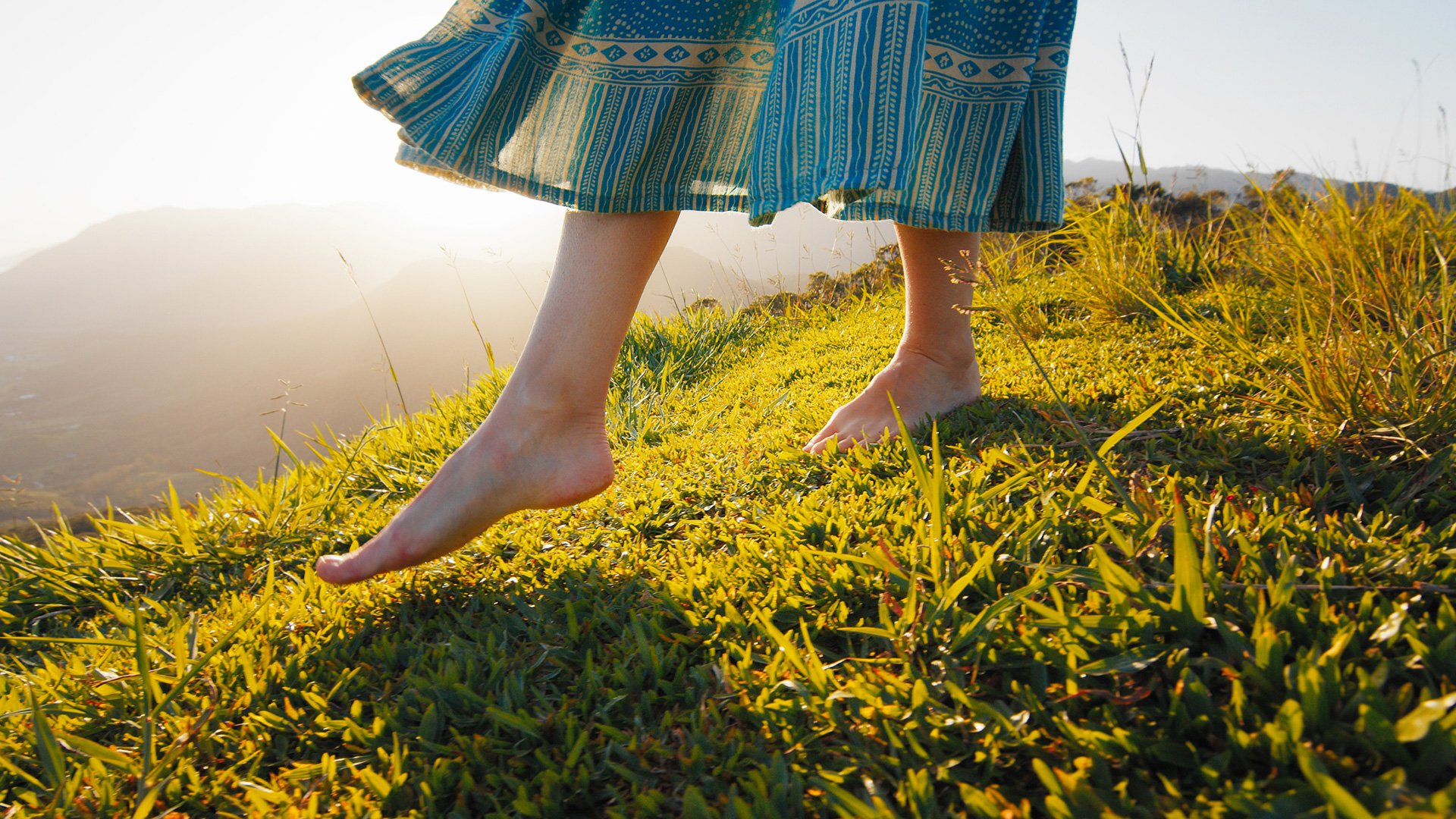 Divorcing mother walking barefoot in the grass