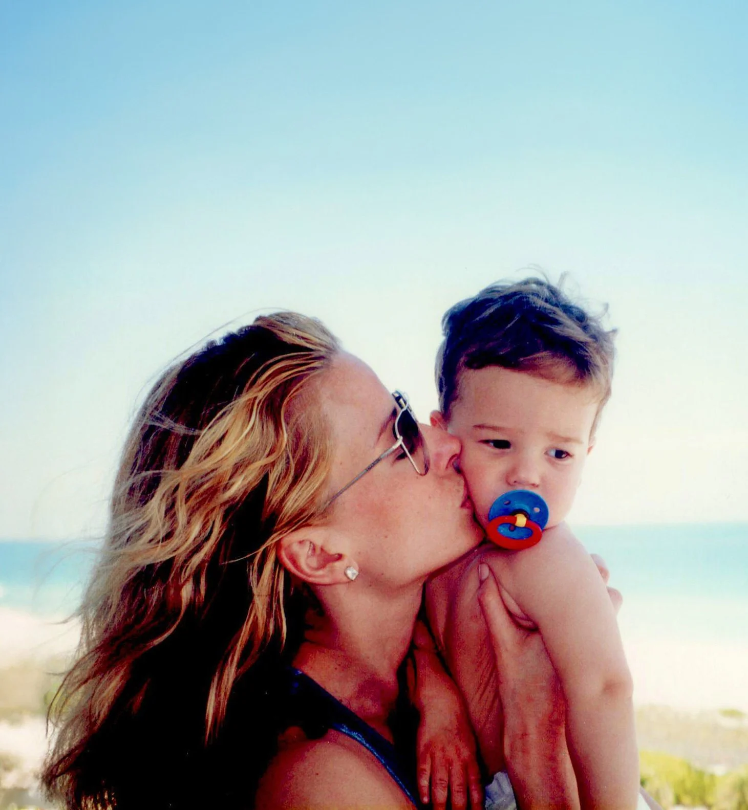 Kristen Noel, divorce coach, with young toddler son at beach