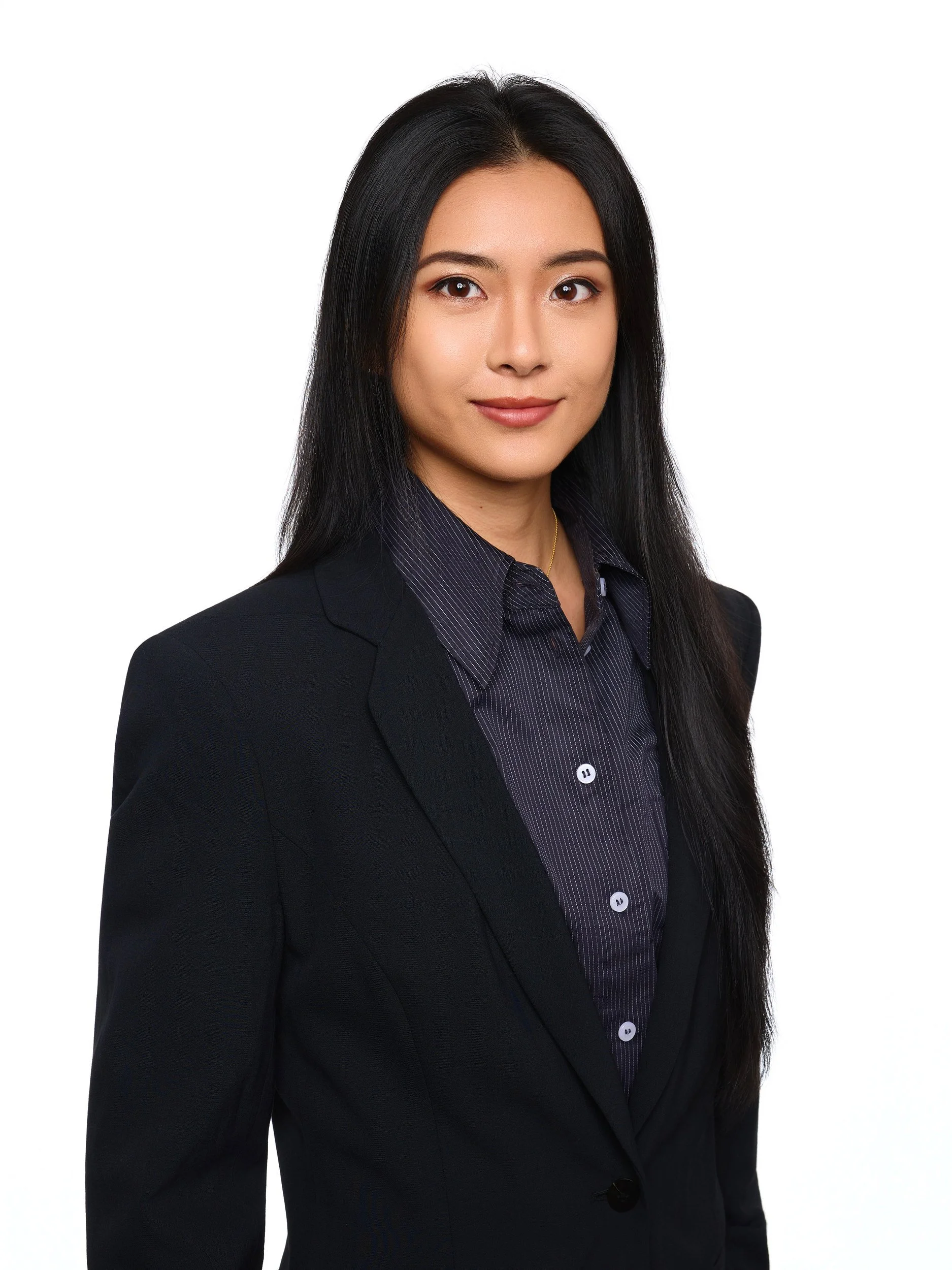 Headshot of a smiling woman in a black blazer on a white background