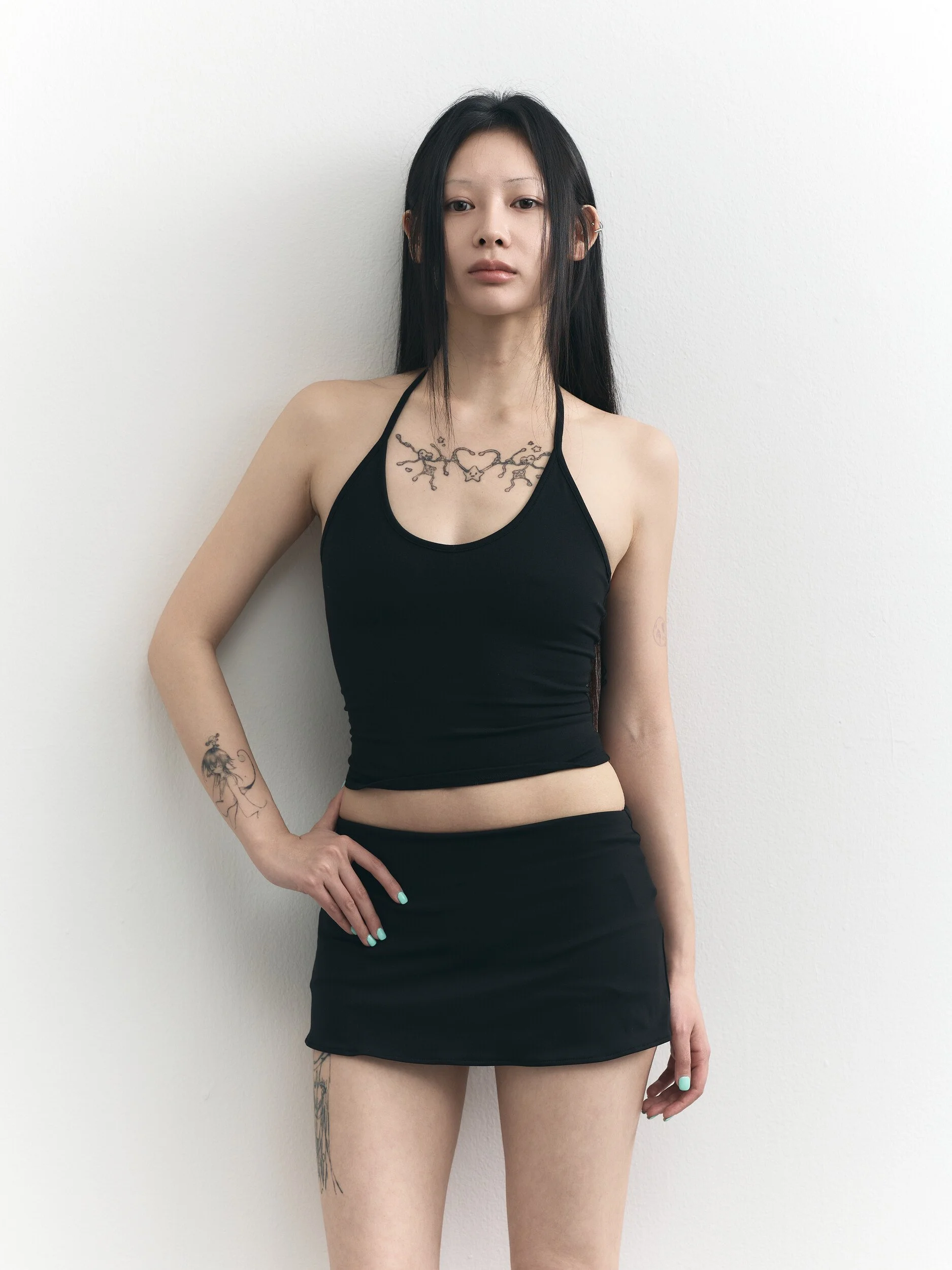 Model digitals: waist-up shot of the model with one hand on her hip