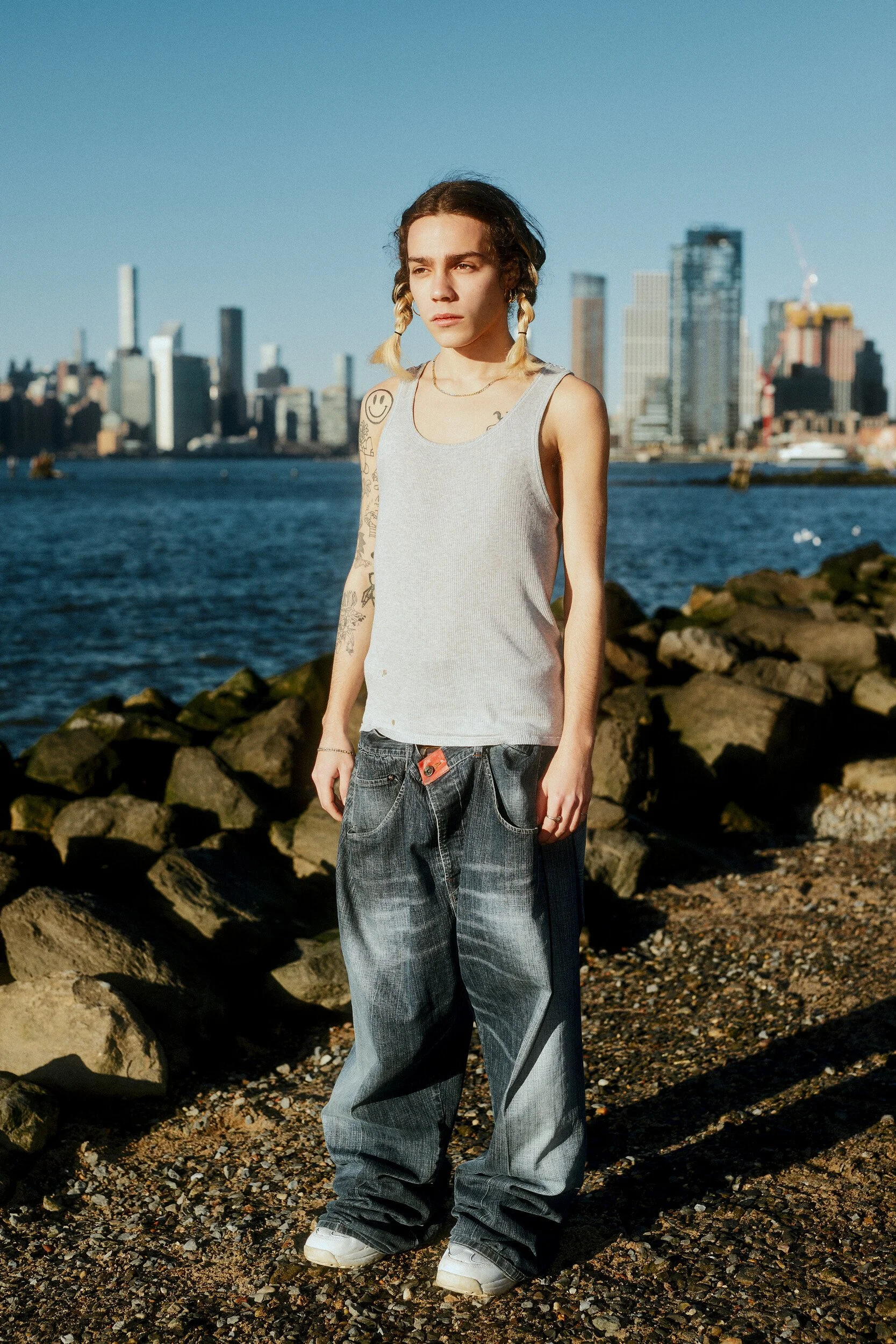 Model digitals by the river: the male model facing the camera, relaxed stance