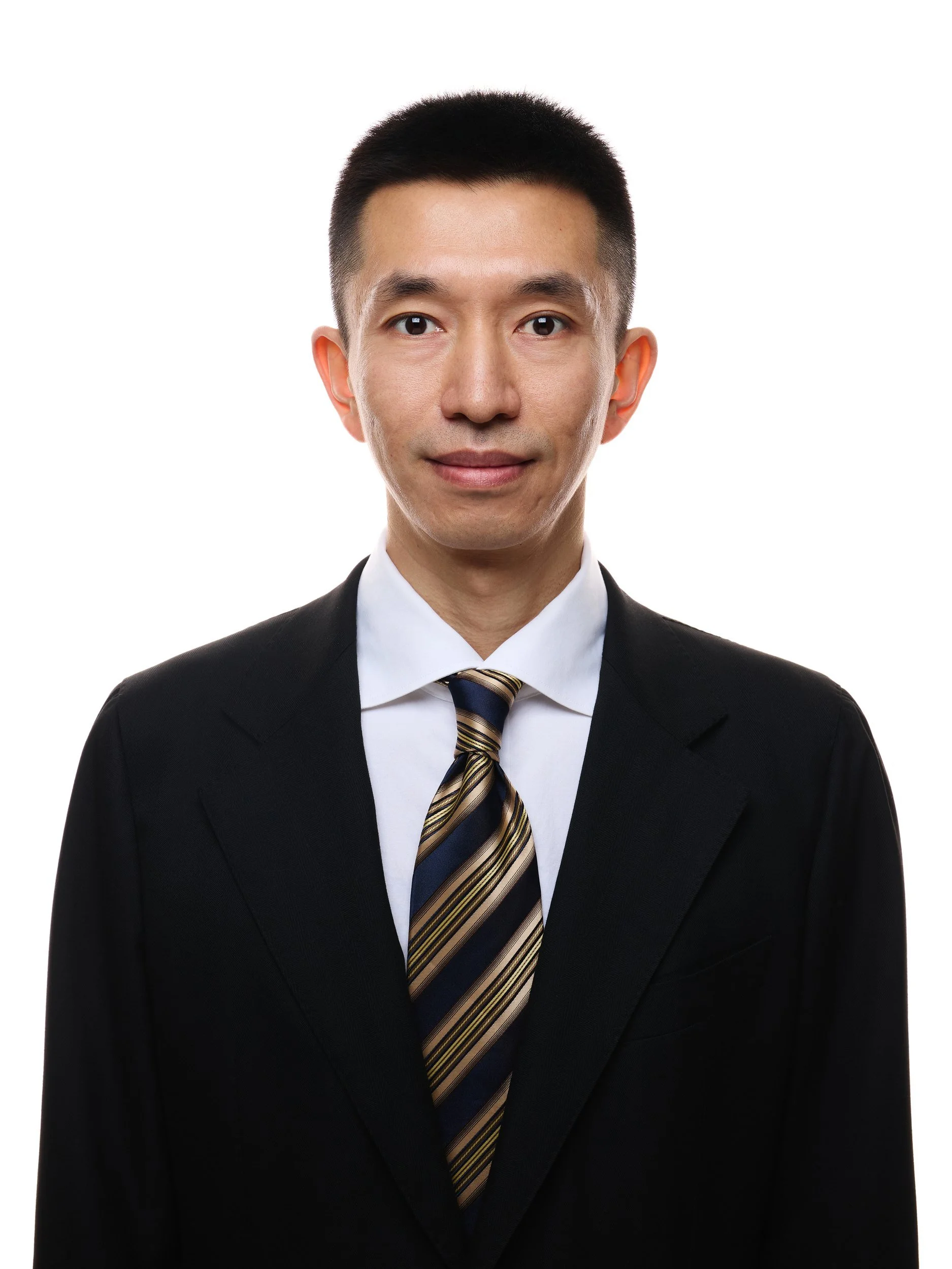 Front-facing ID-style headshot of a man in a black suit and striped tie