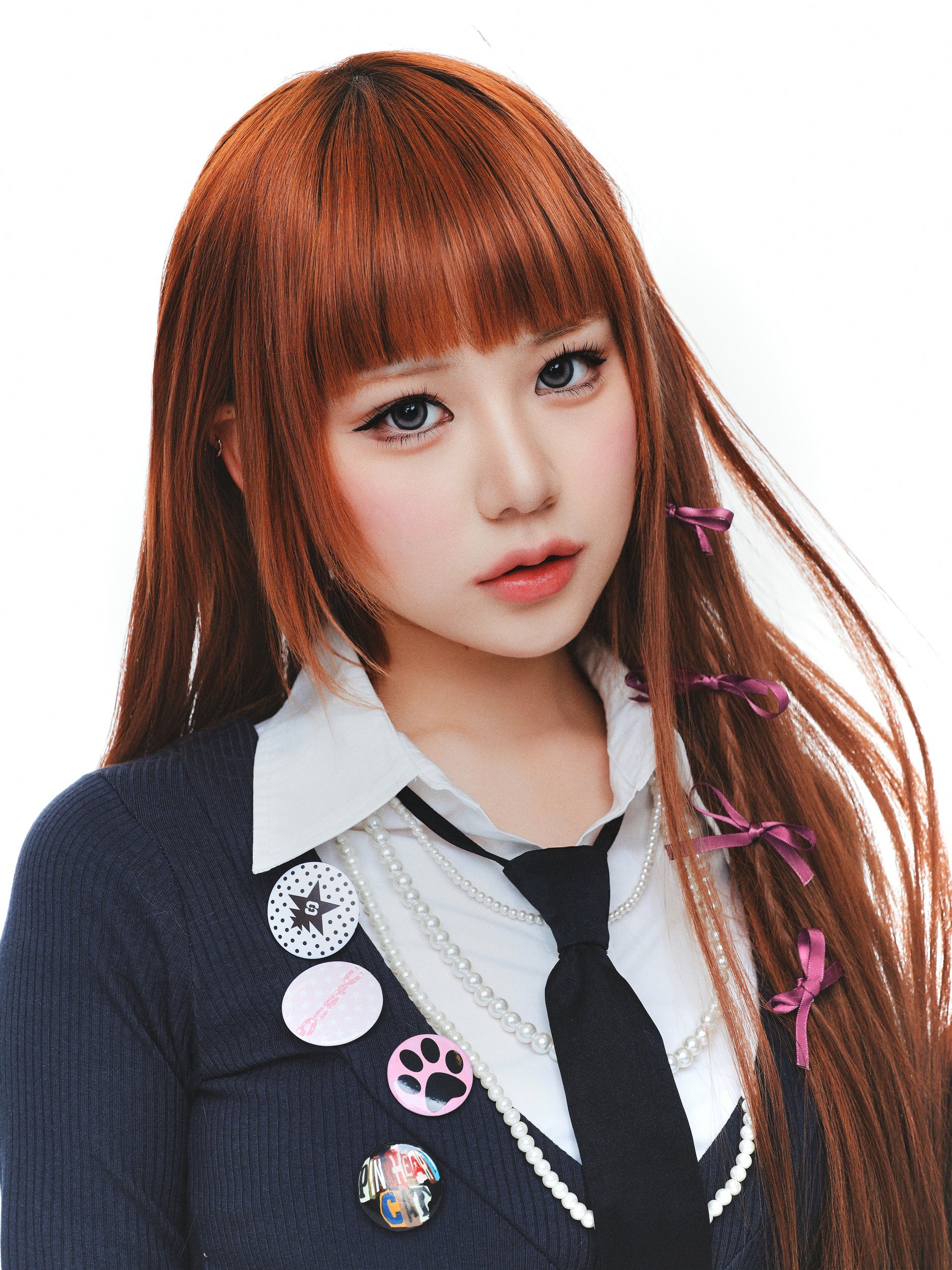 Close-up portrait of a woman with long red hair and bangs in a white collar and black tie