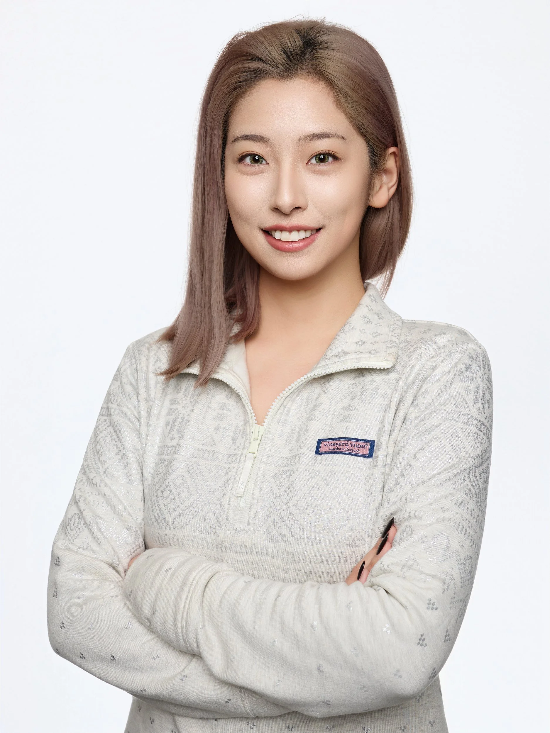 Headshot of a smiling woman in a cream knit pullover with arms crossed
