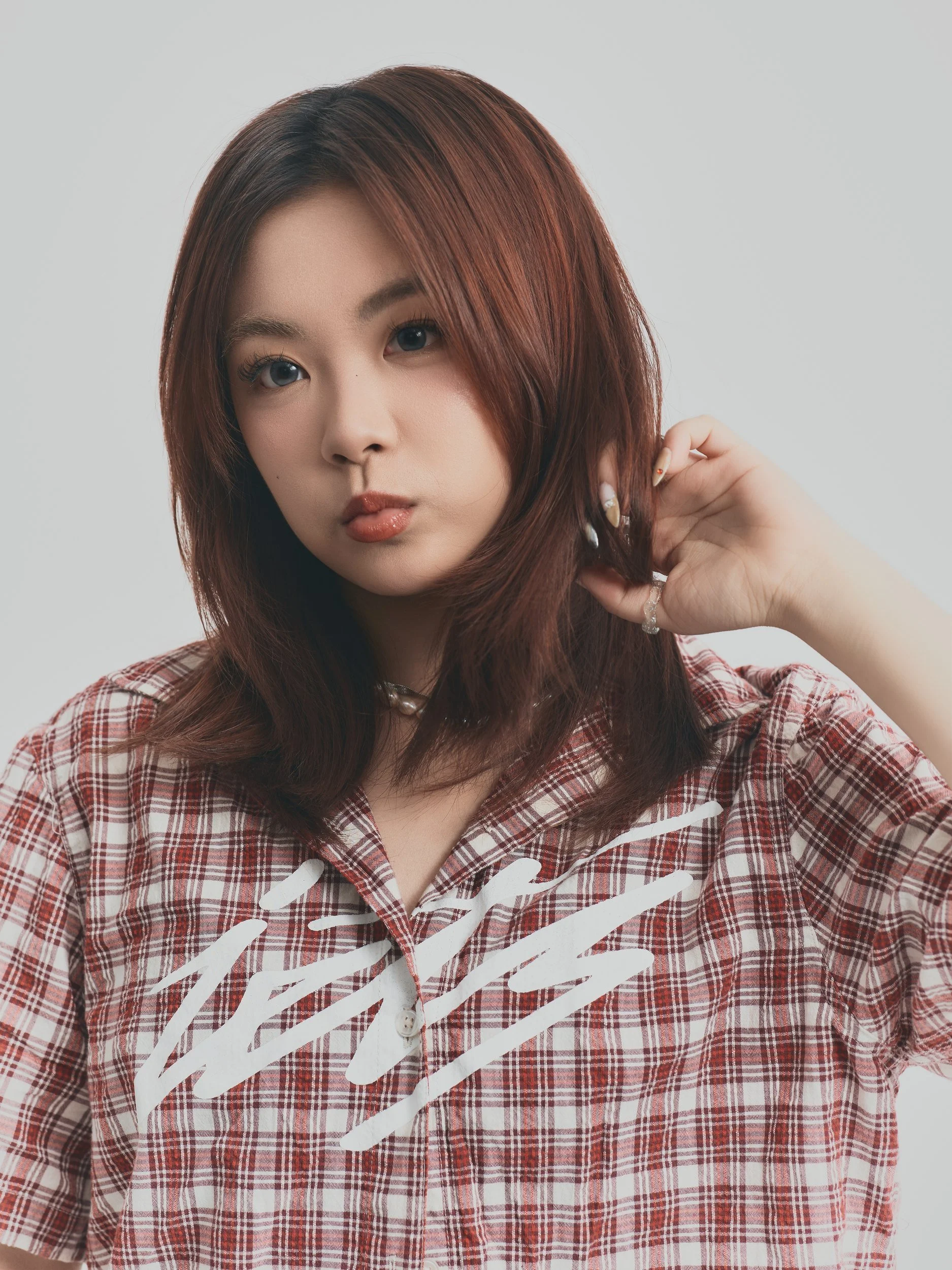 Model test half-length shot of a woman in a red plaid shirt