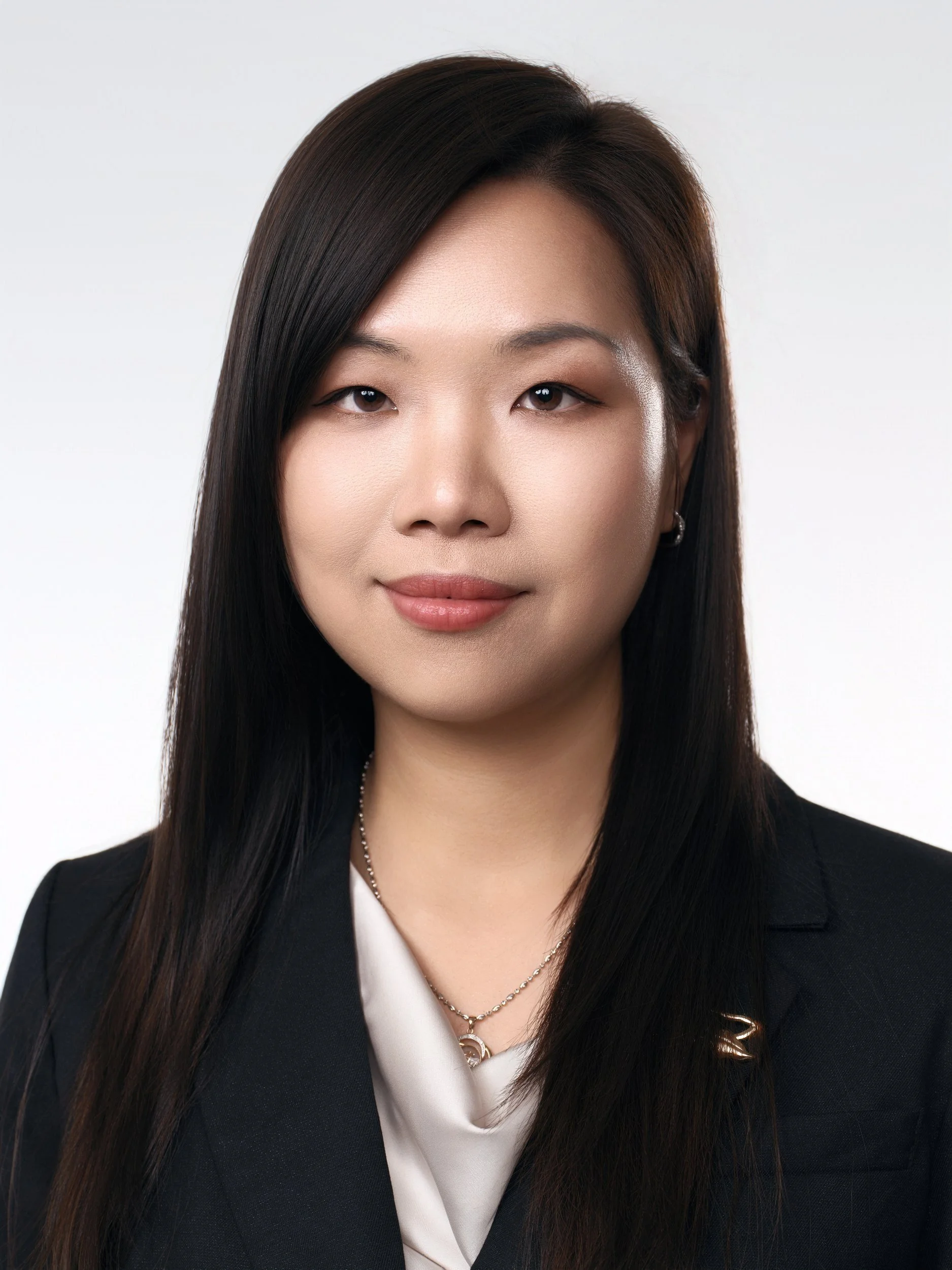 Corporate headshot of a woman in a black blazer