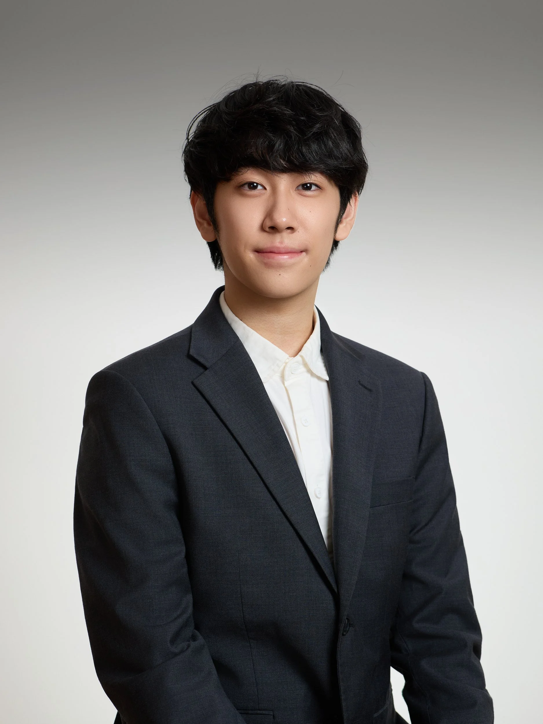 Corporate headshot of a man in a dark suit and white shirt