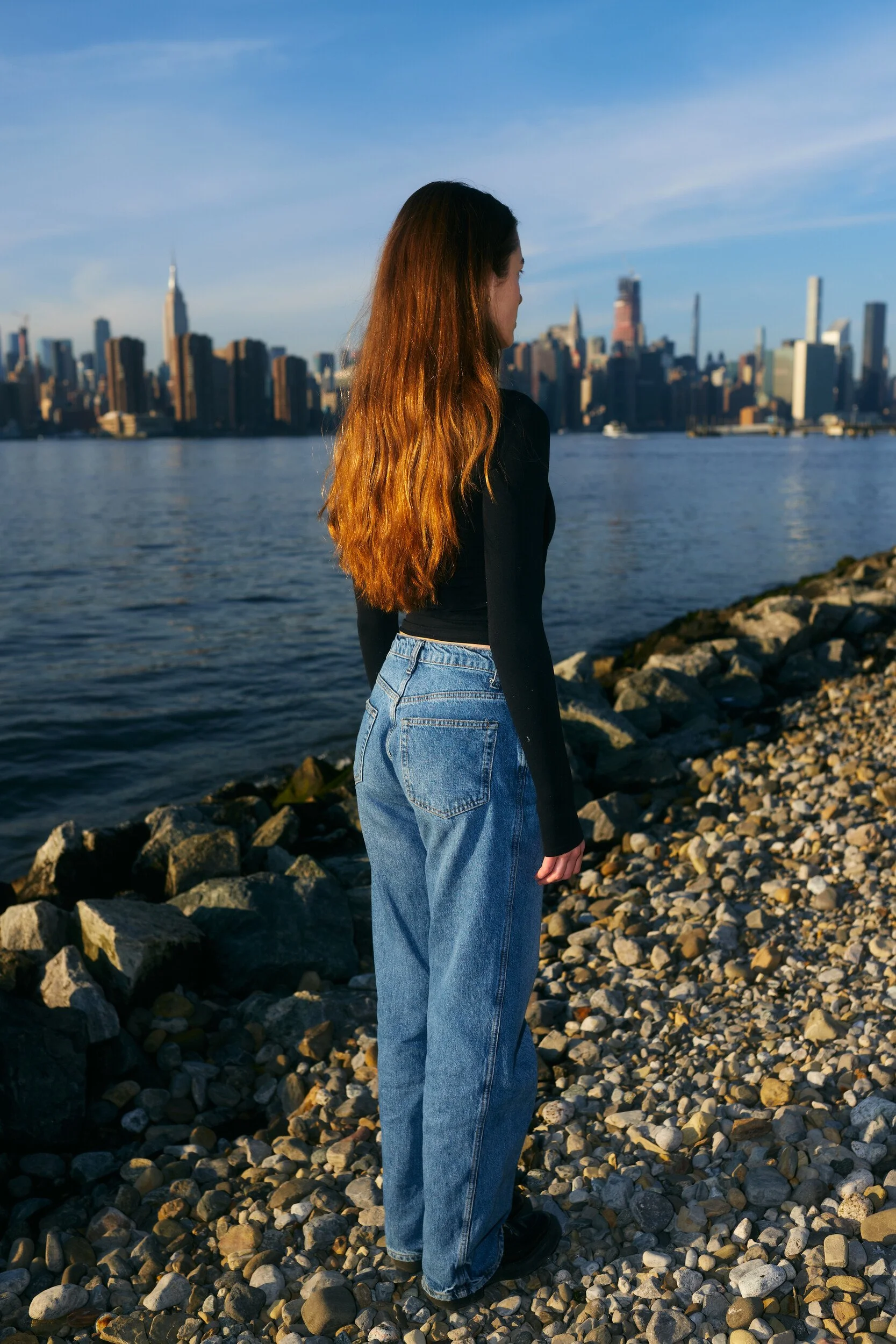 Model digitals by the river: the female model turning away, three-quarter back view