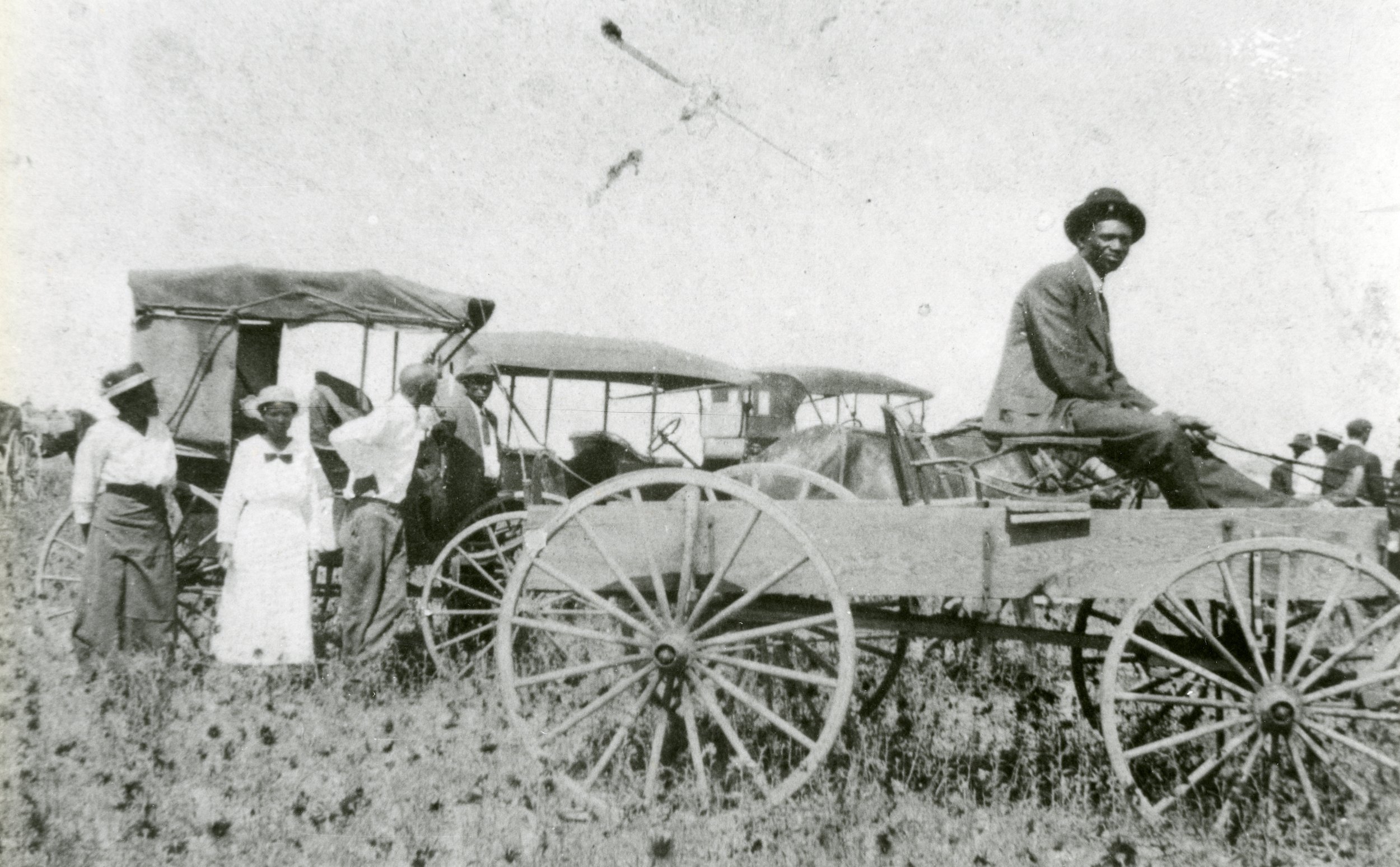 ★  c. 1910-1929, Founder of Dearlield, Oliver T. Jackson seated in wagon with community members in background, Dearfield, CO. Object ID C2_3015.0001.1C, City of Greeley Museums, Permanent Collection. 