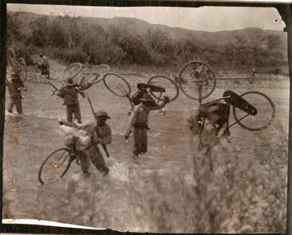 1896, 25th Infantry Bicycle Corps crossing a creek, location unknown. University of Montana Mansfield Library, Edward H, Boos Photographs, Mss 672 [672.239].
