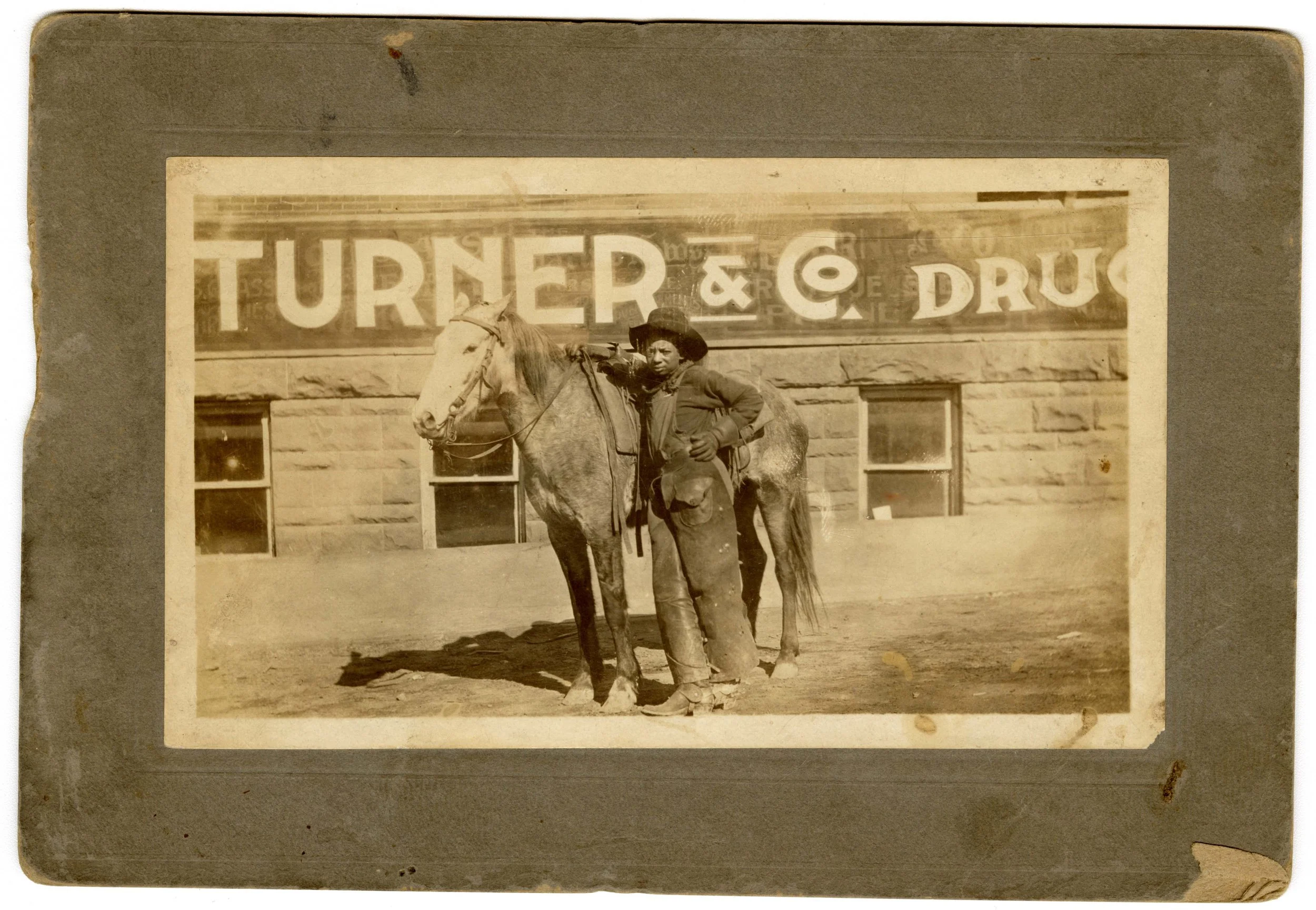 ★ c. 1890, Black Cowboy poses in front of a store with his horse. National Cowboy & Western Heritage Museum, Dickinson Research Center, Oklahoma City, OK, 2003.105.