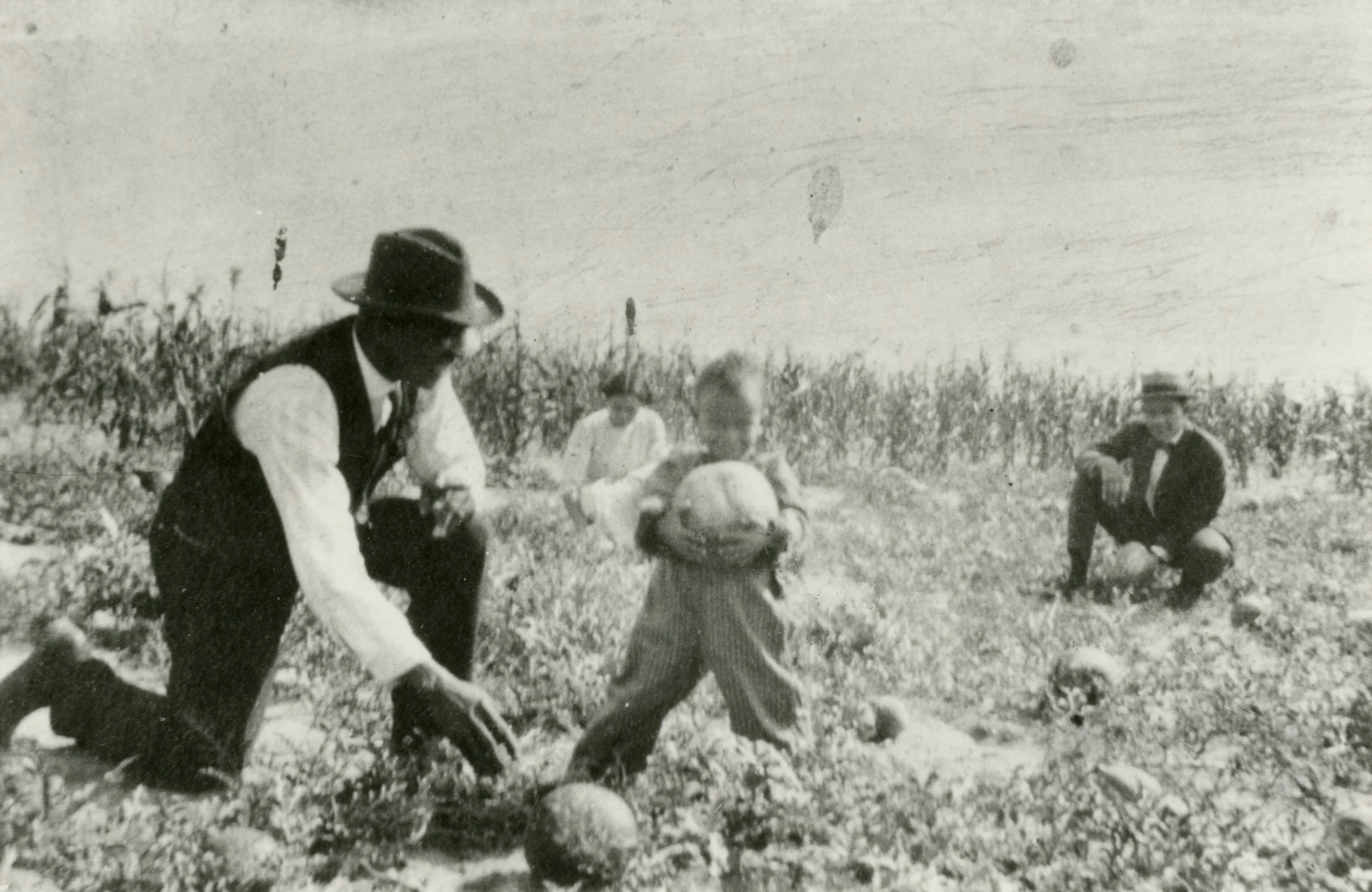 ★  c. 1910 - 1929, Oliver T. Jackson, founder of town, kneeling in melon field next to child, Dearfield, Object ID CO. C1_3015.0001.2D, City of Greeley Museums, Permanent Collection. 