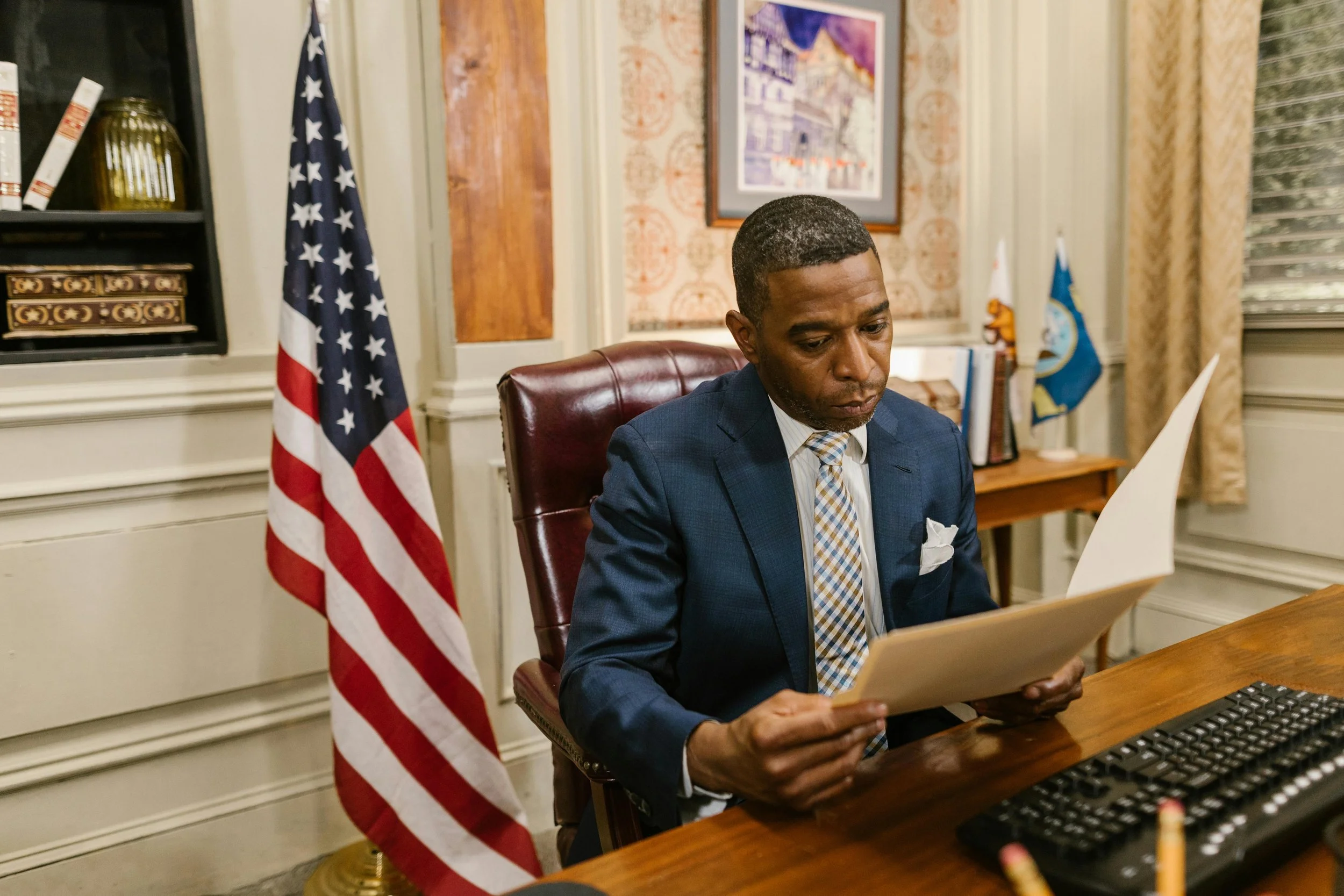 A government official reading programs offering foreclosure assistance.