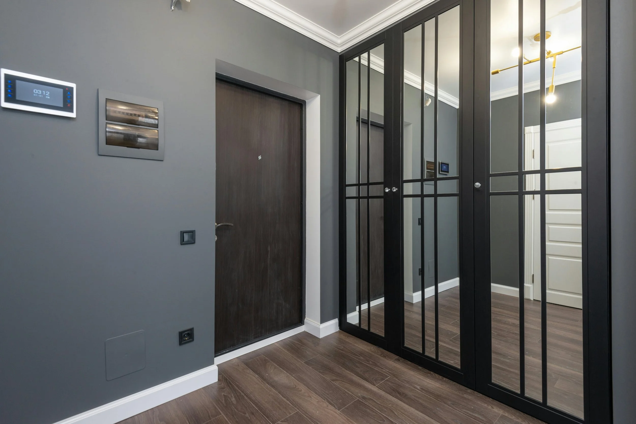 Modern hallway with a smart home entry panel and mirrored closet
