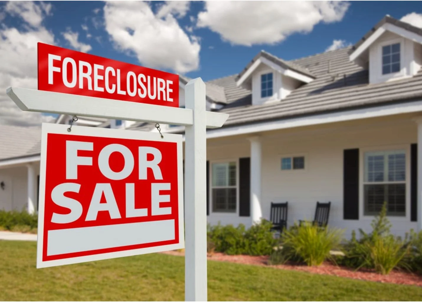 A foreclosure sign in front a home.