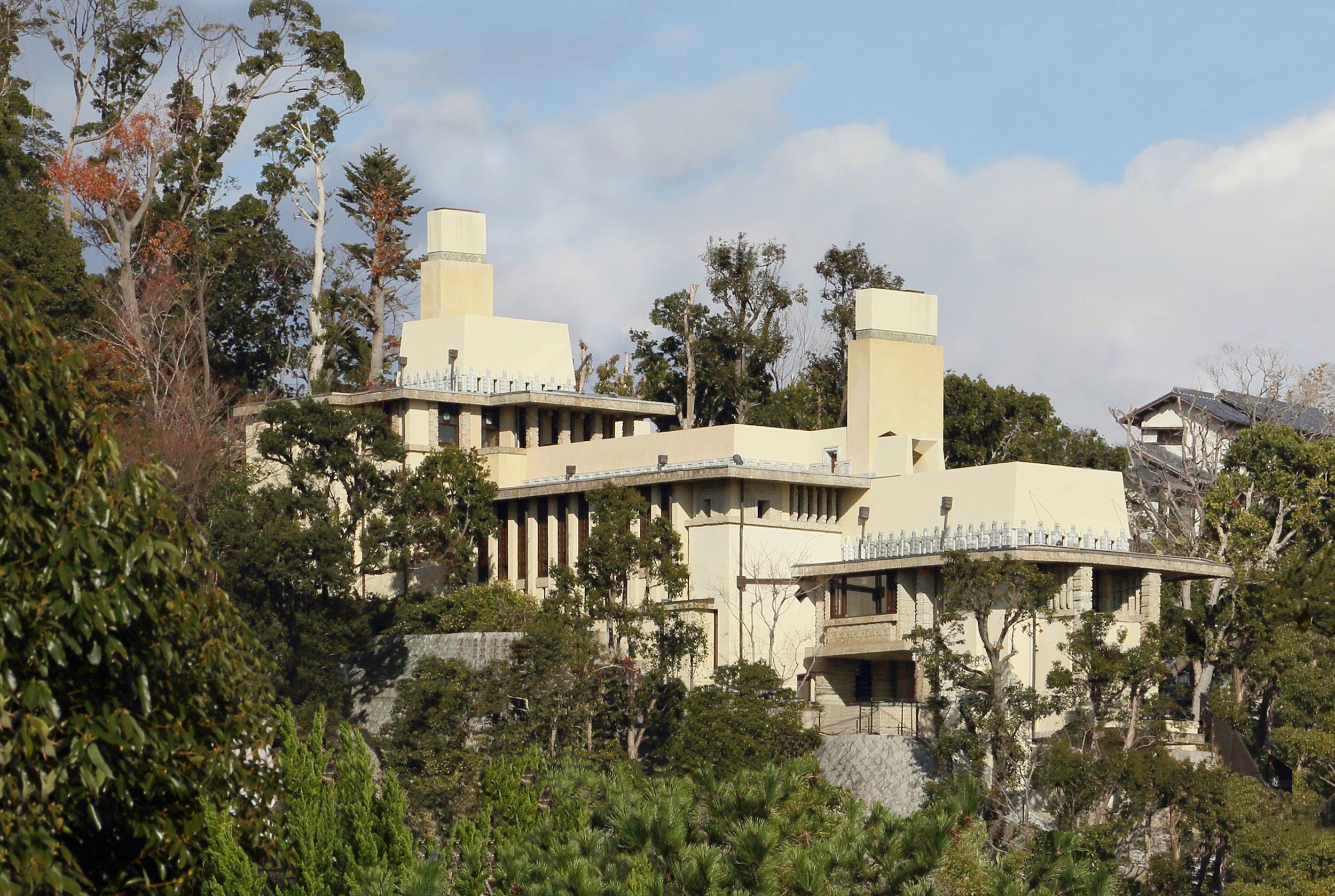 Yodoko Guest House by Frank Lloyd Wright — a cream-toned terraced villa nestled among autumn trees on Ashiya's Rokko hillside, Hyogo.