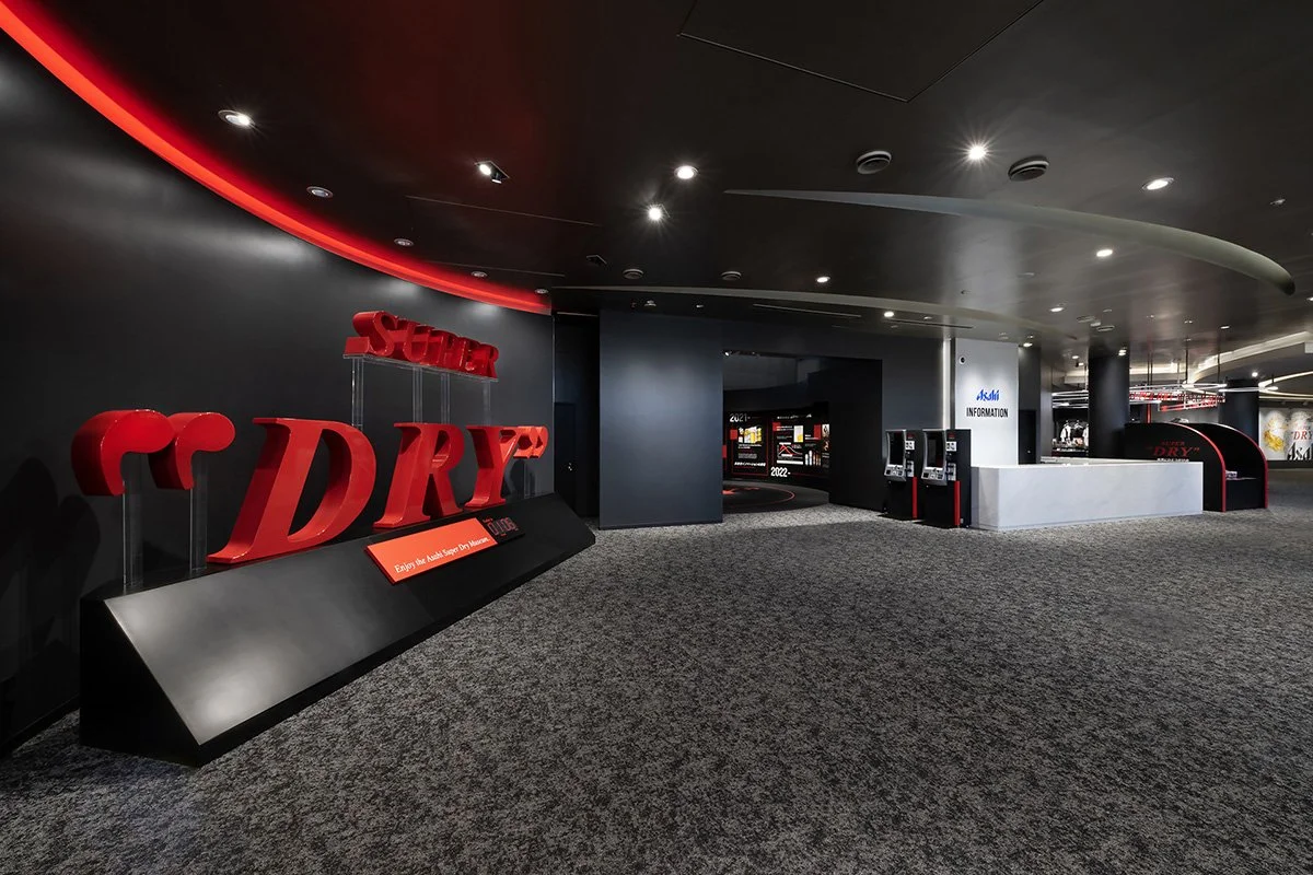 Bold red "DRY" sculpture at the sleek black entrance of the Asahi Super Dry Museum in Ibaraki — an immersive Japanese beer experience.