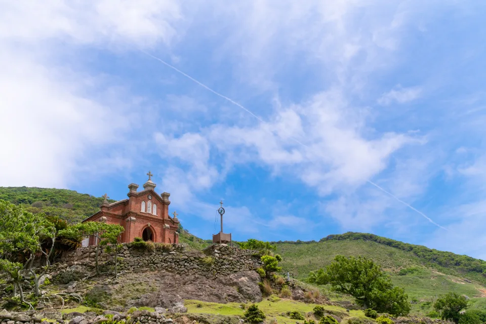 Former Nokubi Church, a red-brick UNESCO heritage site on a green hillside on uninhabited Nozaki Island, Goto, Nagasaki.