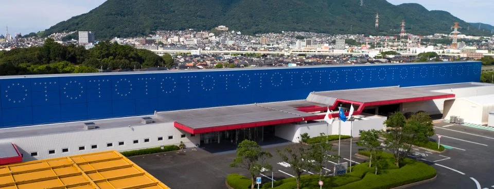 Large factory exterior of Sun Aqua TOTO in Kitakyushu — an inclusive workplace where people with disabilities thrive alongside colleagues.