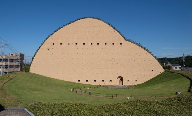 Earth-mound museum by Terunobu Fujimori rising under blue skies in Tajimi — Japan's hidden tile capital in Gifu Prefecture.
