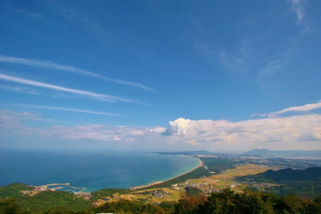 Panoramic view from Yugawayama summit over Genkai Sea and the curving pine-lined coast of Sanri Matsubara in Okagaki, Fukuoka.