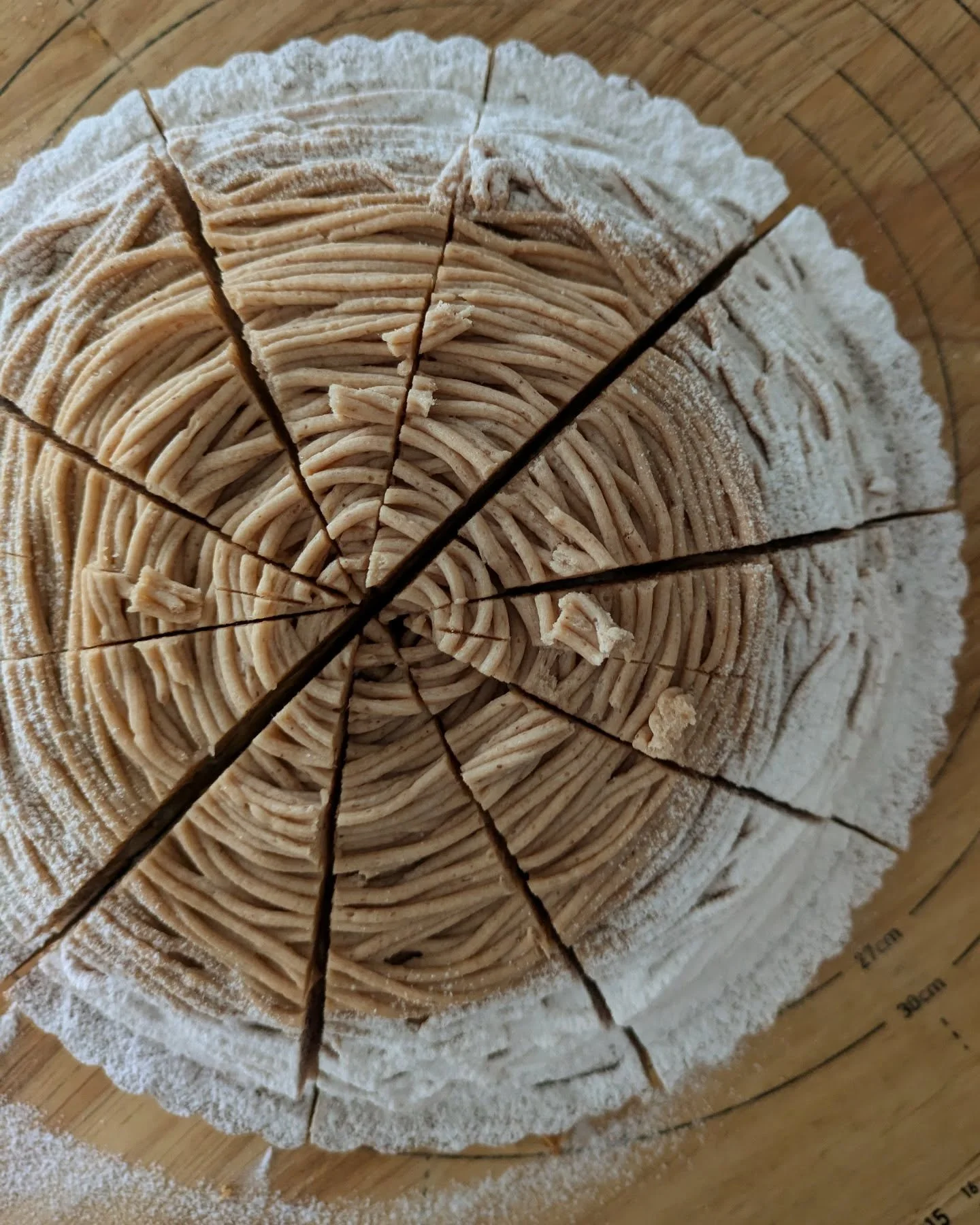 A modern building with glass doors and windows, decorated with flags and signs, including a cartoon tiger mascot wearing a white hat and cape, outdoors on a sunny day with trees in the background.