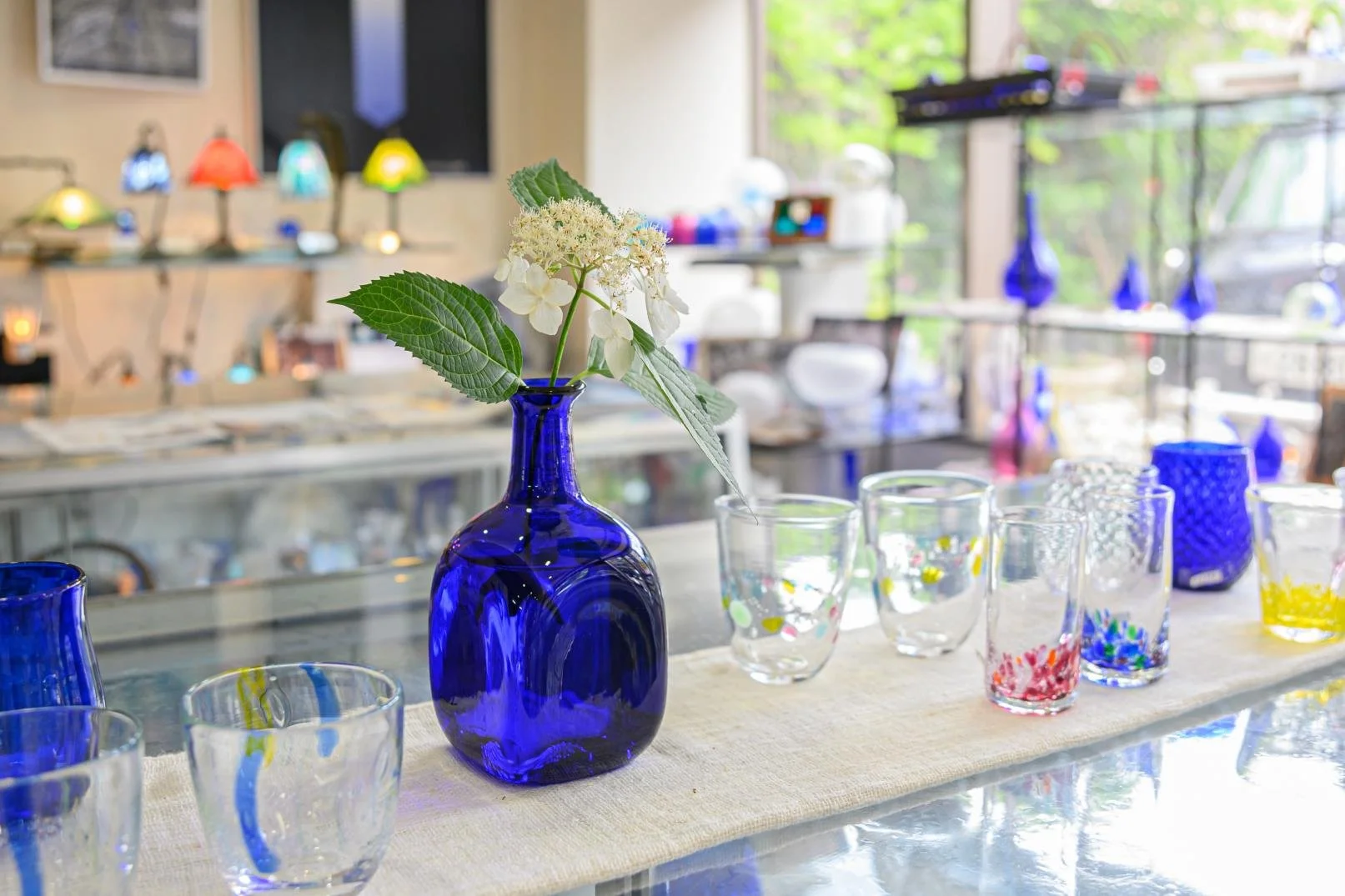 Cobalt blue Vidro glass vase with white hydrangea and handcrafted glassware at Rurian Glass Studios, Nagasaki — a heritage workshop.