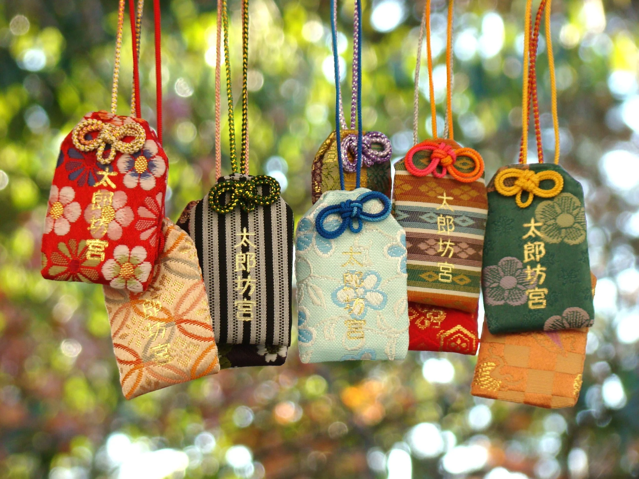 Colorful handcrafted omamori charms hanging at Tarobogu Shrine — a rare sacred ritual experience in Shiga, Japan.