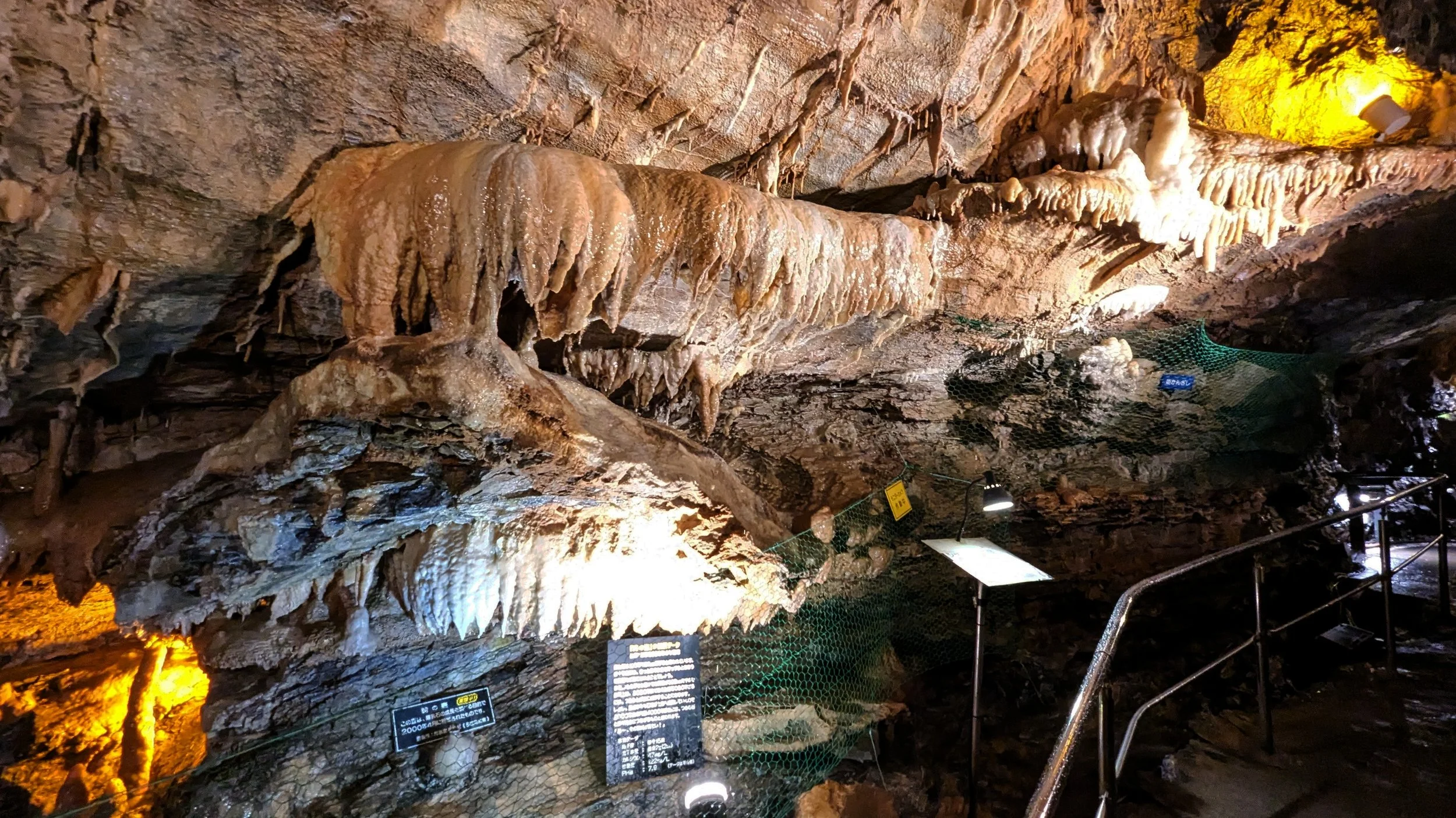 Amber-lit stalactites and ancient flowstone formations inside Ryugashido Cavern, a spectacular limestone cave in Hamamatsu, Japan.