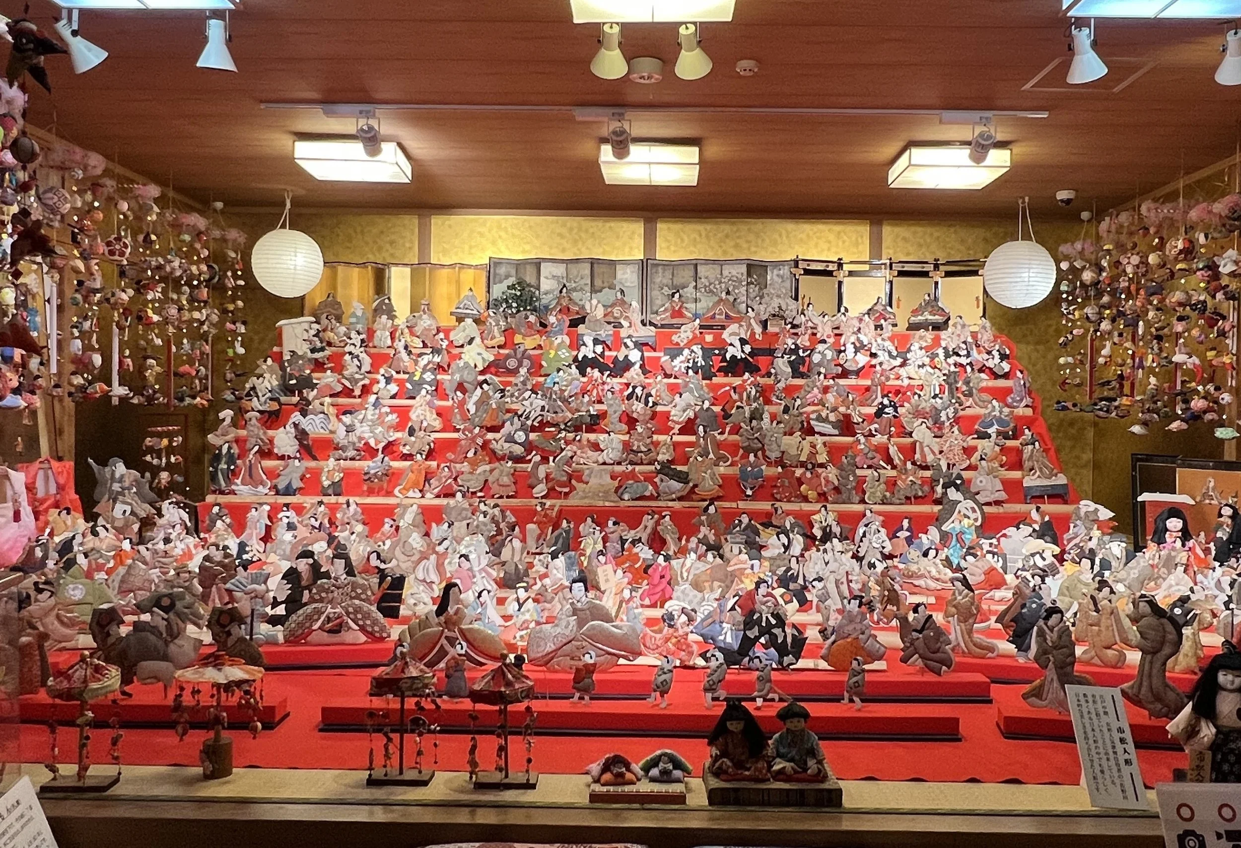Hundreds of hina dolls on red tiered platforms fill Hina Goten museum in Hita, Oita — a hidden gem of Japanese craft tradition.